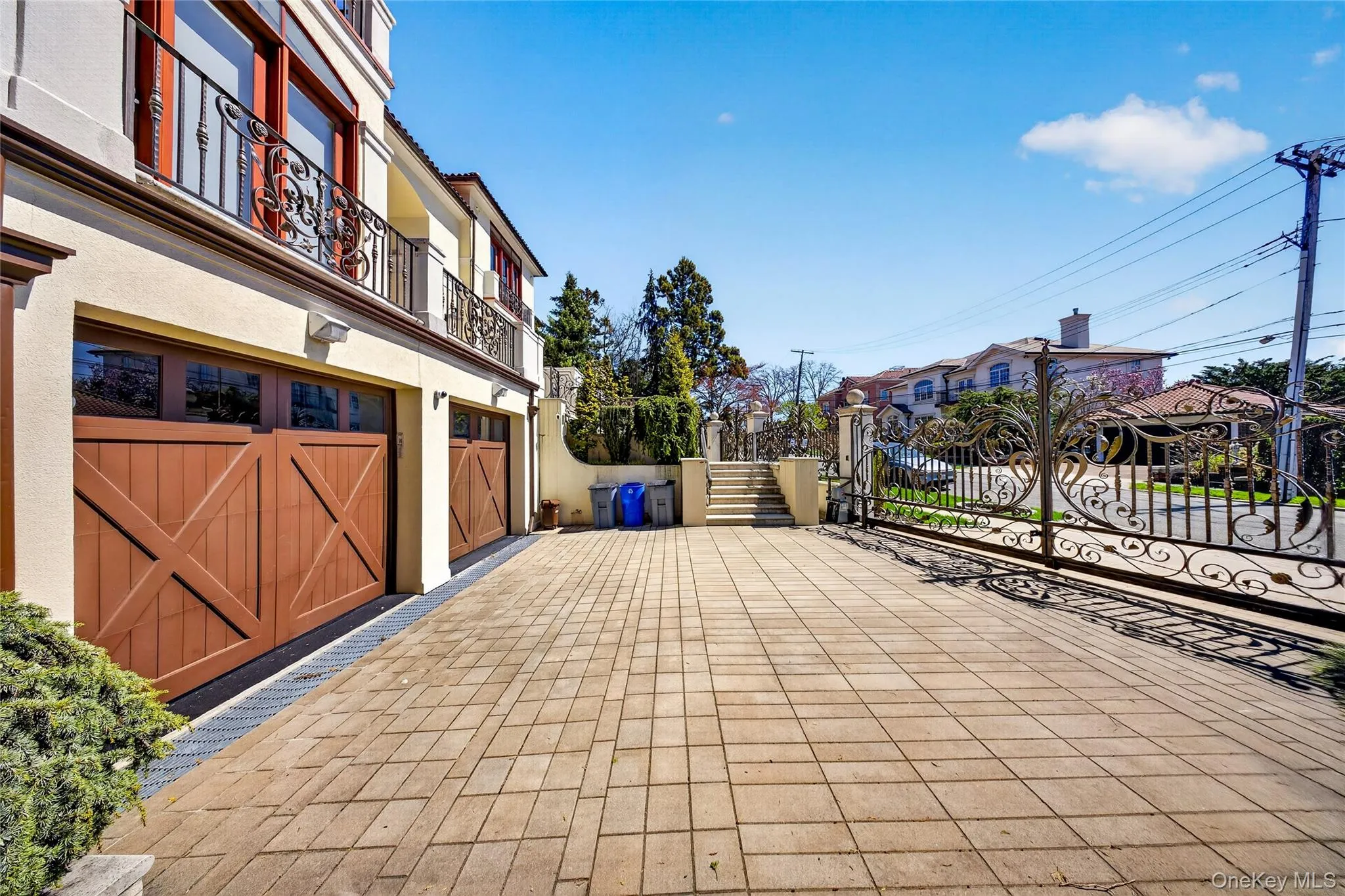 View of patio / terrace featuring a gate, an attached garage, and a residential view View of patio / terrace featuring a gate, an attached garage, and a residential view