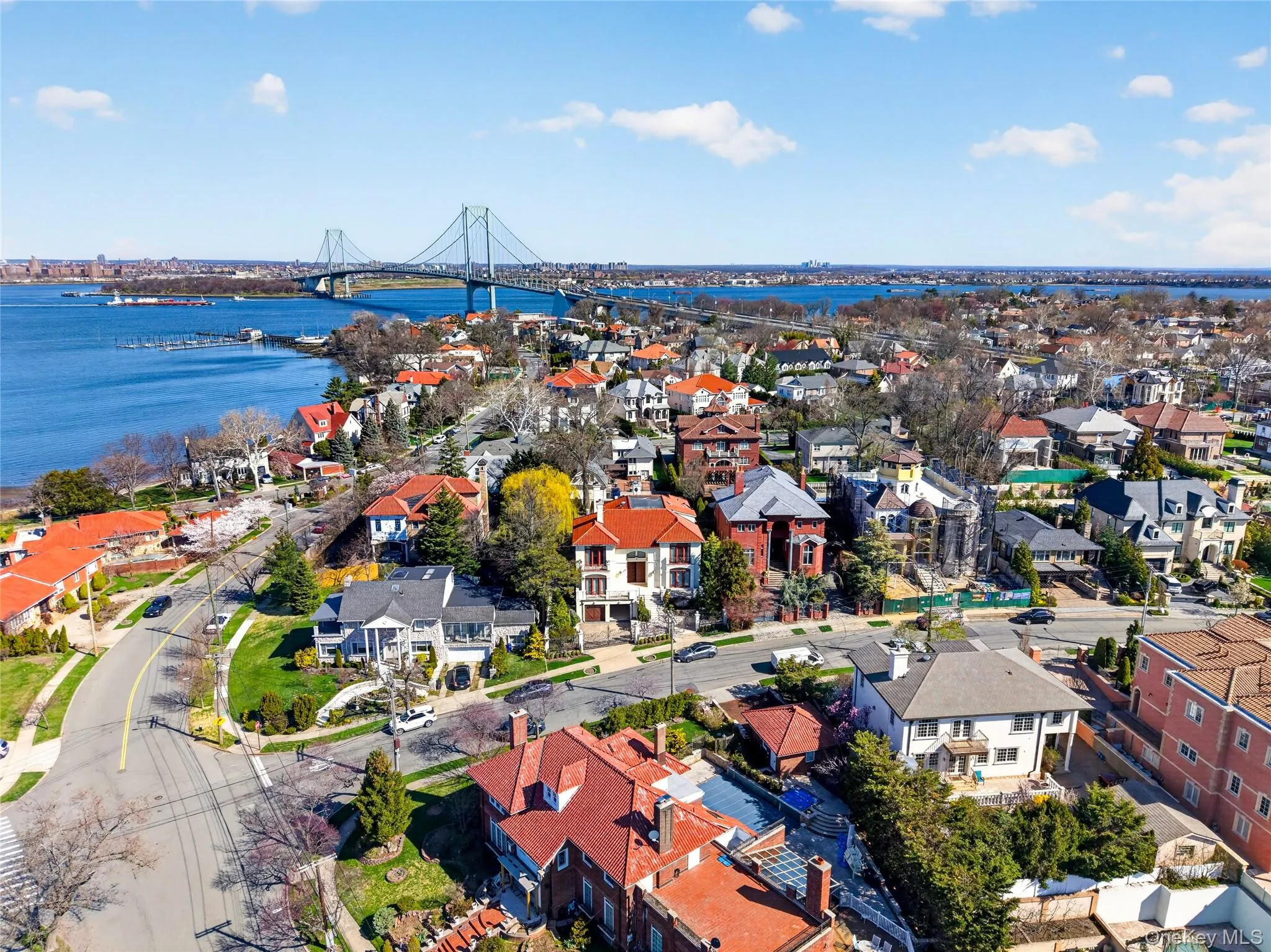 Aerial view of residential area with a notable bridge and a large body of water Aerial view of residential area with a notable bridge and a large body of water