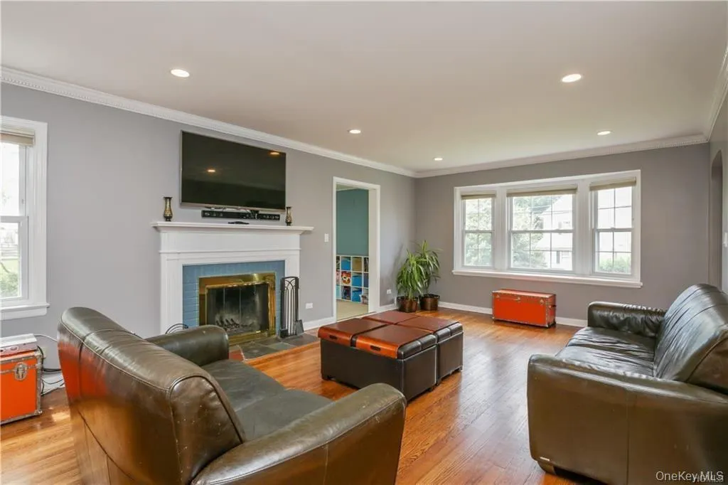 Formal sunlit and spacious living room with working fireplace. Gorgeous hardwood floors, walls of windows allow for sunlight all day long. Formal sunlit and spacious living room with working fireplace. Gorgeous hardwood floors, walls of windows allow for sunlight all day long.