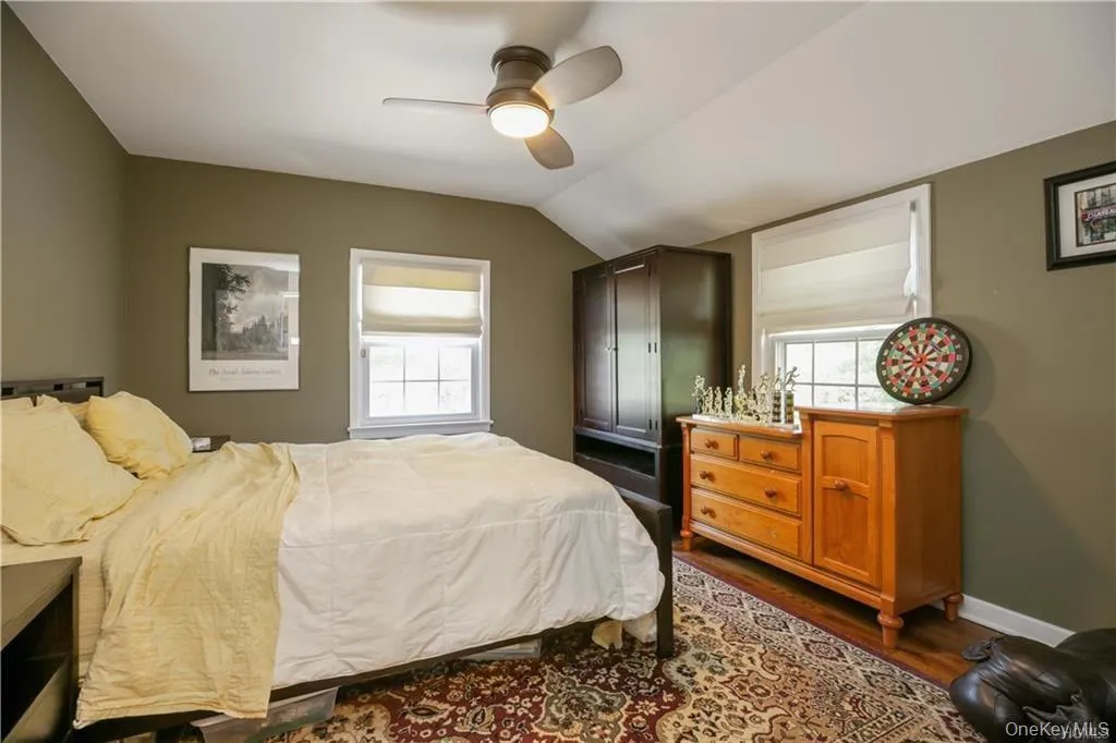 Bedroom with two large windows and beautiful hardwood floors. Bedroom with two large windows and beautiful hardwood floors.