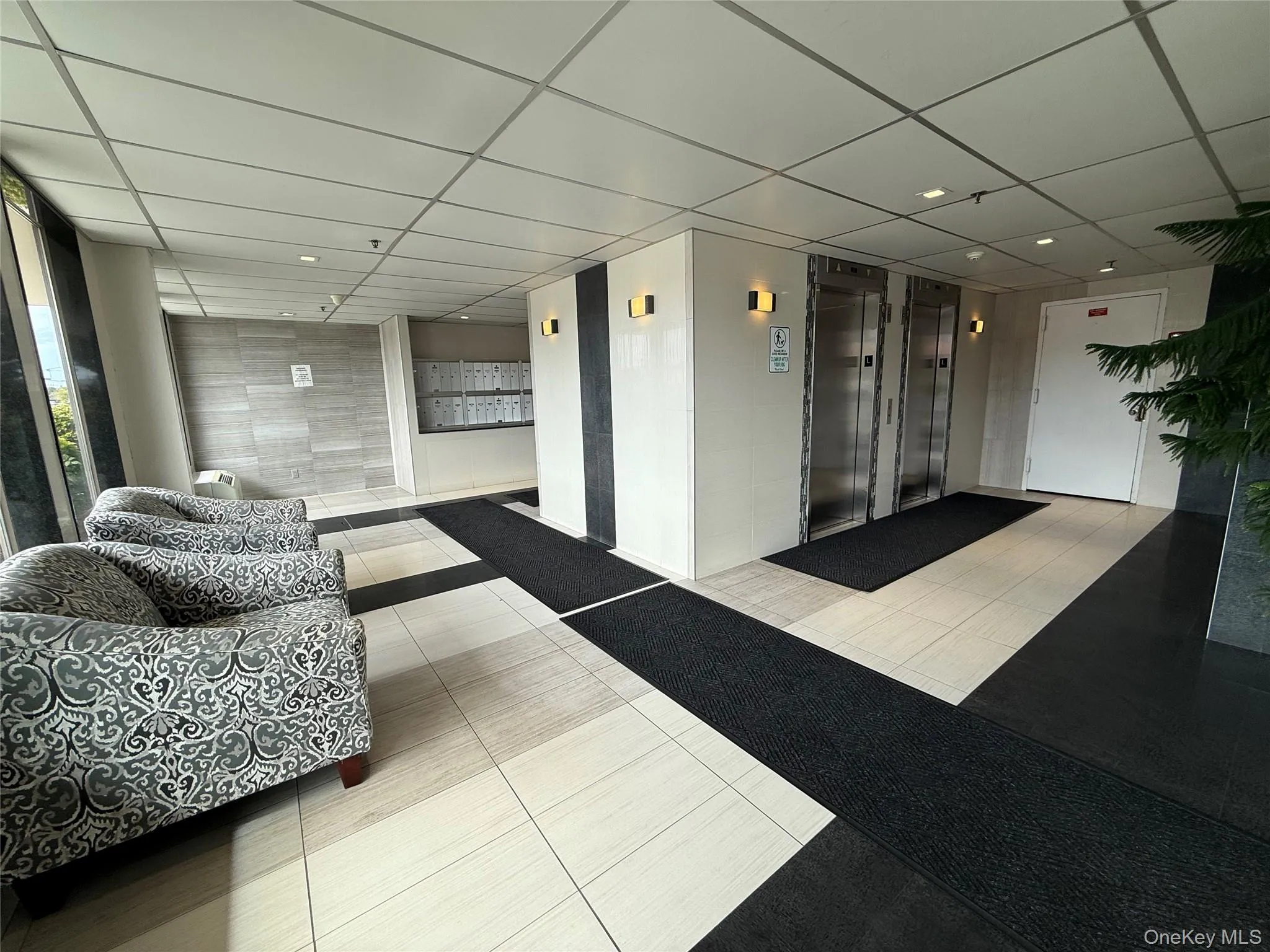 Community lobby with a paneled ceiling and recessed lighting Community lobby with a paneled ceiling and recessed lighting