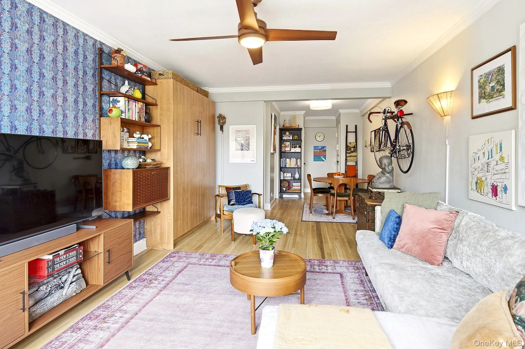 Large living room with hardwood floors open to a dining area Large living room with hardwood floors open to a dining area