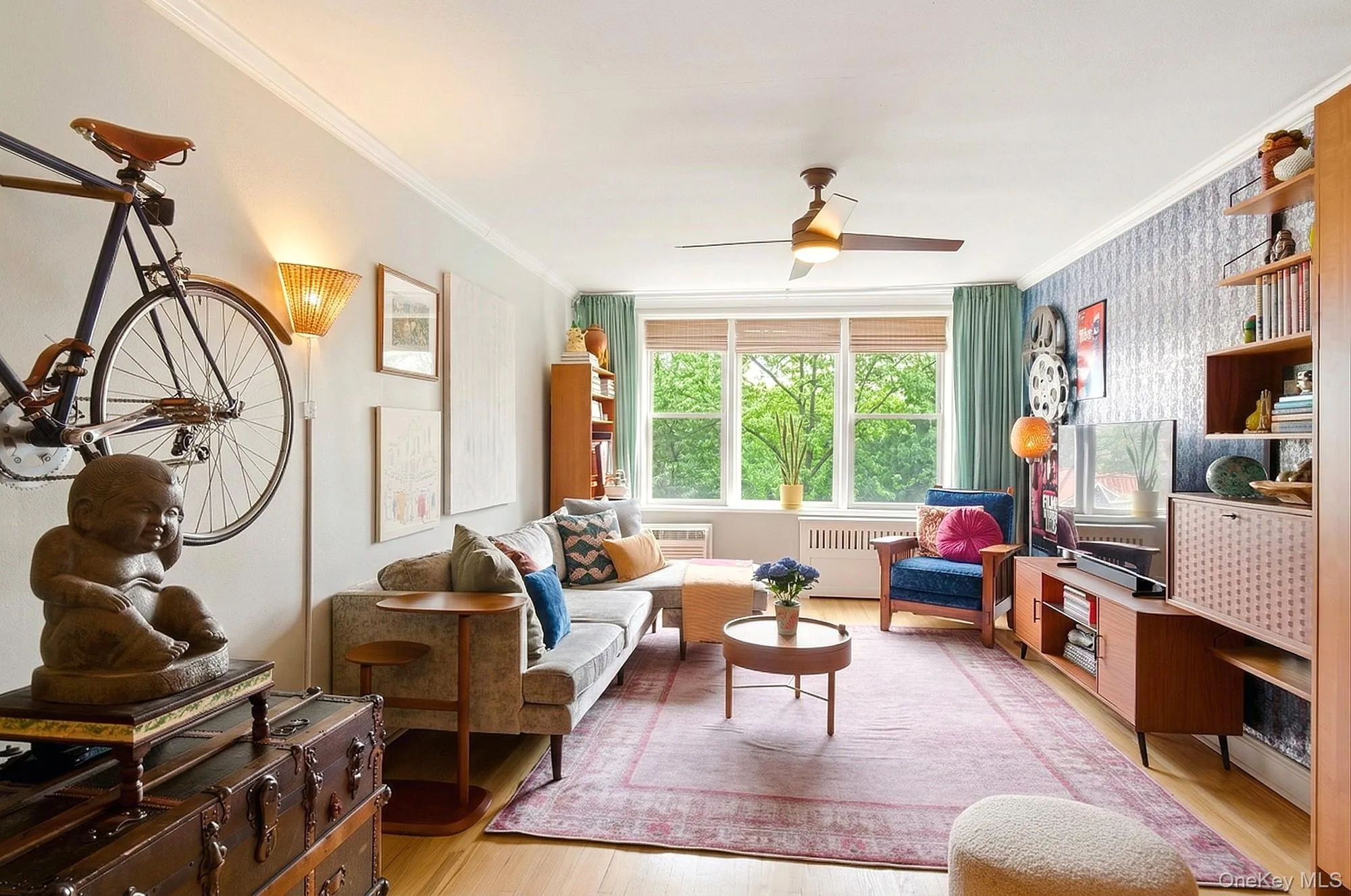 Large living room with a triple window and hardwood floors Large living room with a triple window and hardwood floors