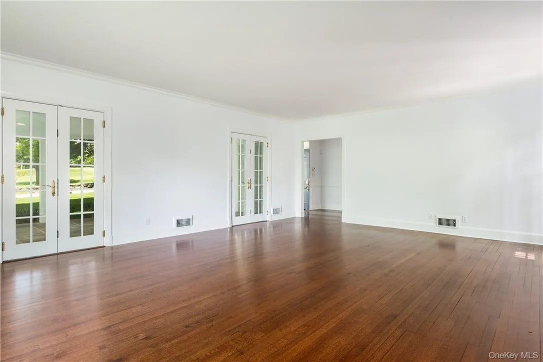 The living room also features two sets of French Doors to the covered front porch. The living room also features two sets of French Doors to the covered front porch.