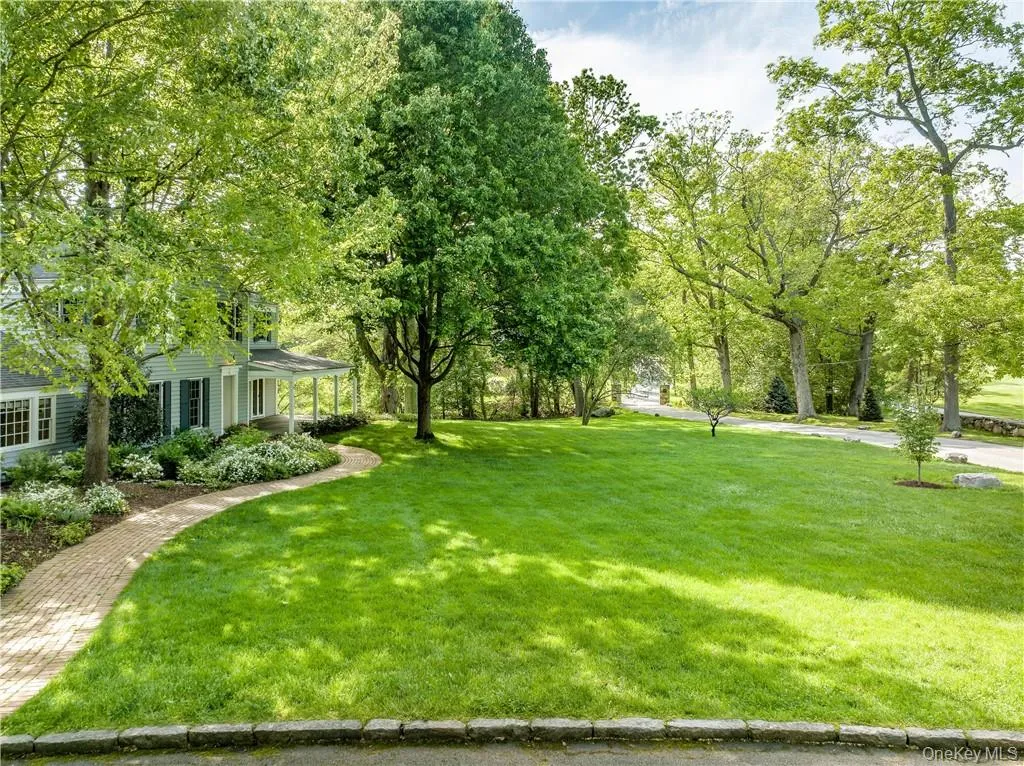Spacious front yard showing walkway to the front door and golf course views. Spacious front yard showing walkway to the front door and golf course views.