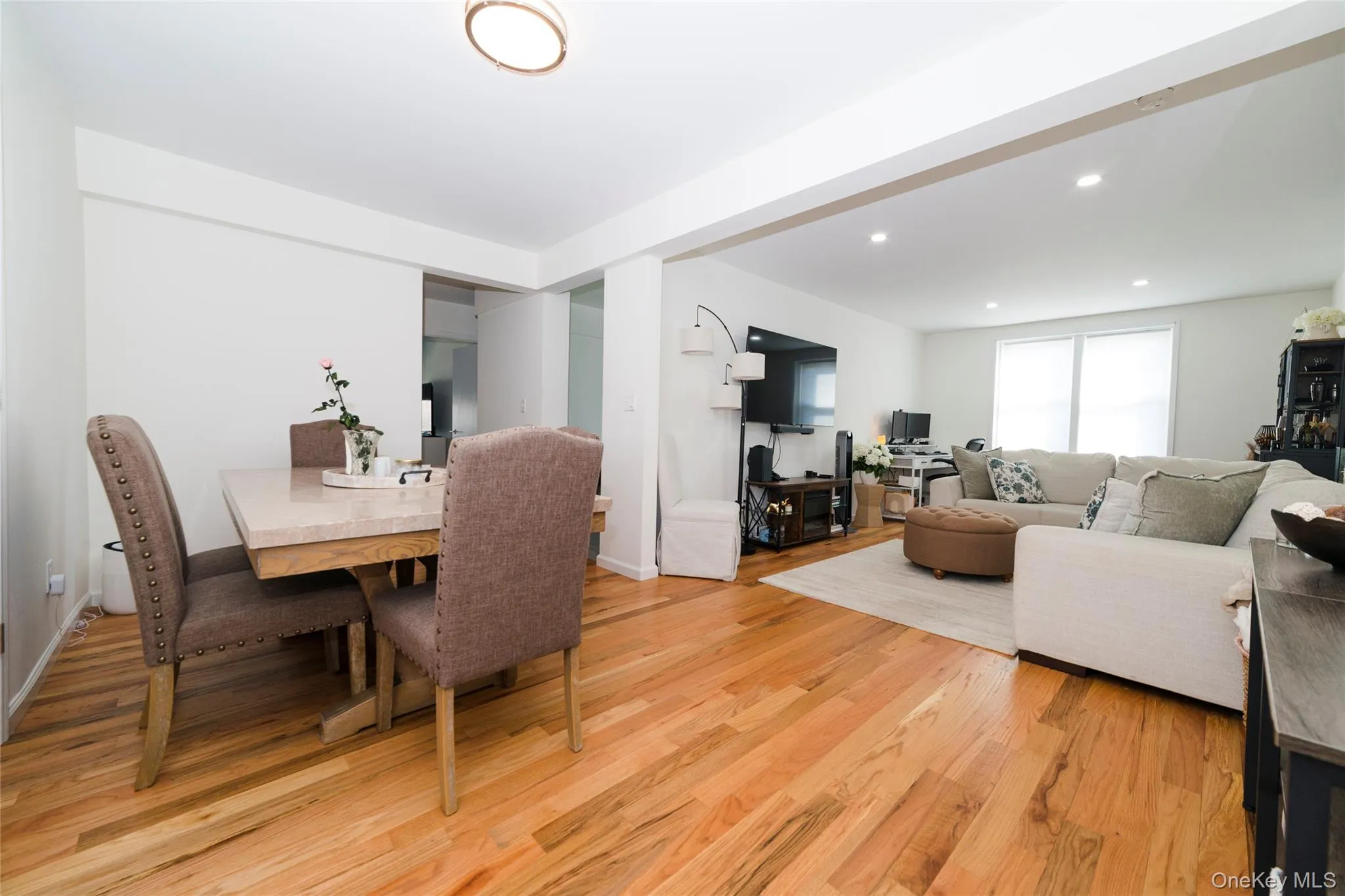 The property features light-toned hardwood flooring throughout, extending into an open living area with recessed lighting The property features light-toned hardwood flooring throughout, extending into an open living area with recessed lighting