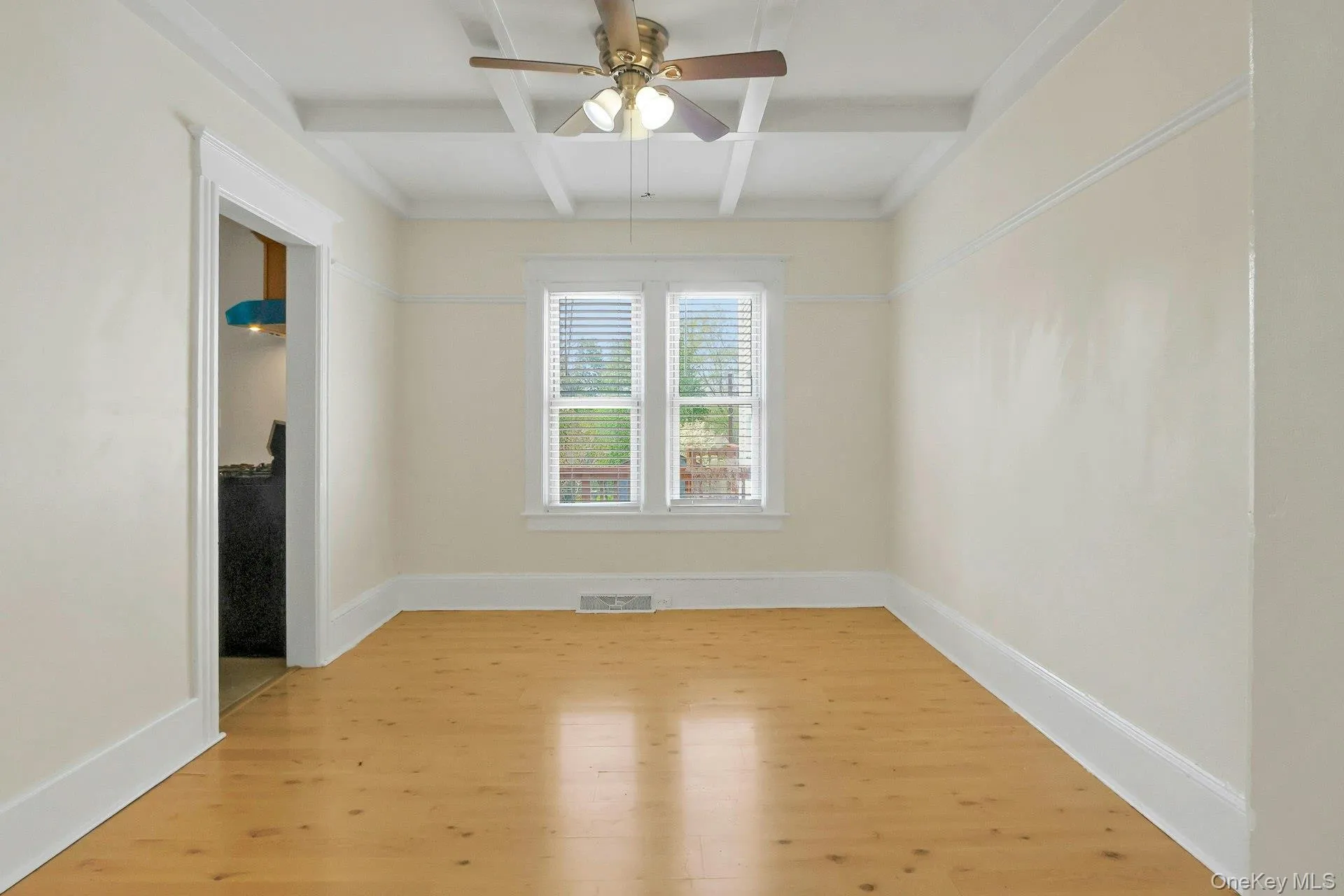 Dining room with laminate floors and coffered ceiling Dining room with laminate floors and coffered ceiling