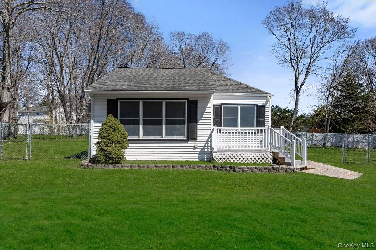 Charming single-story property featuring white siding and dark shutters Charming single-story property featuring white siding and dark shutters