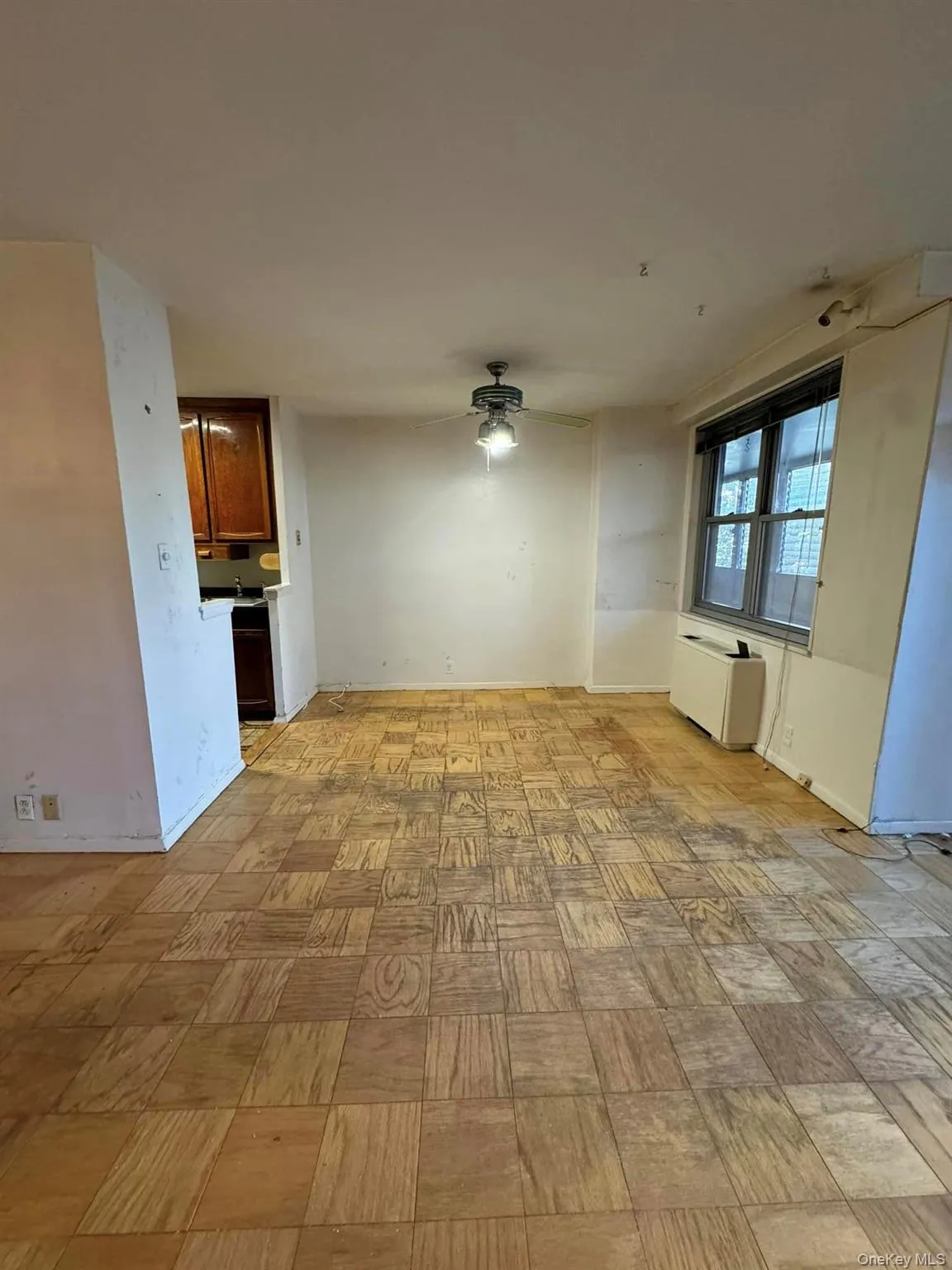 Unfurnished living room featuring a ceiling fan Unfurnished living room featuring a ceiling fan