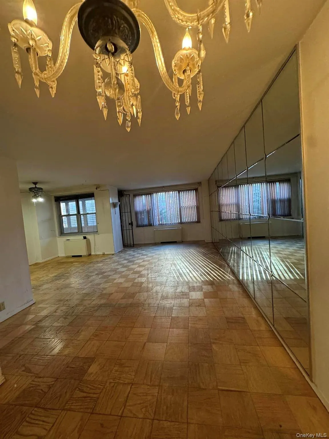 Unfurnished living room with a chandelier and tile patterned floors Unfurnished living room with a chandelier and tile patterned floors