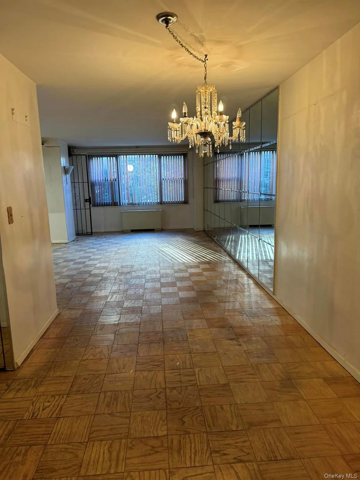Unfurnished room with a chandelier and baseboards Unfurnished room with a chandelier and baseboards