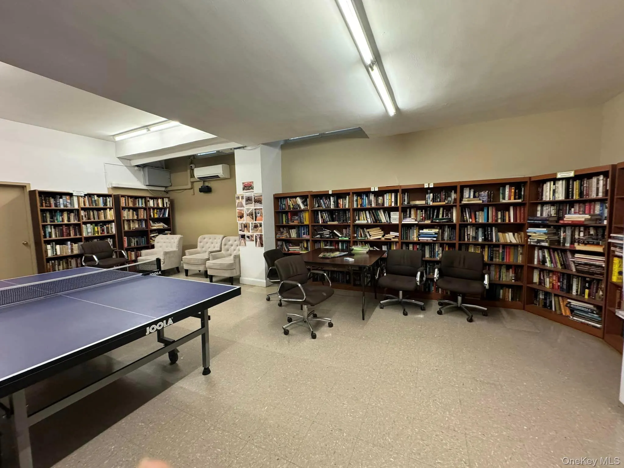 Recreation room featuring tile patterned floors and a wall unit AC Recreation room featuring tile patterned floors and a wall unit AC