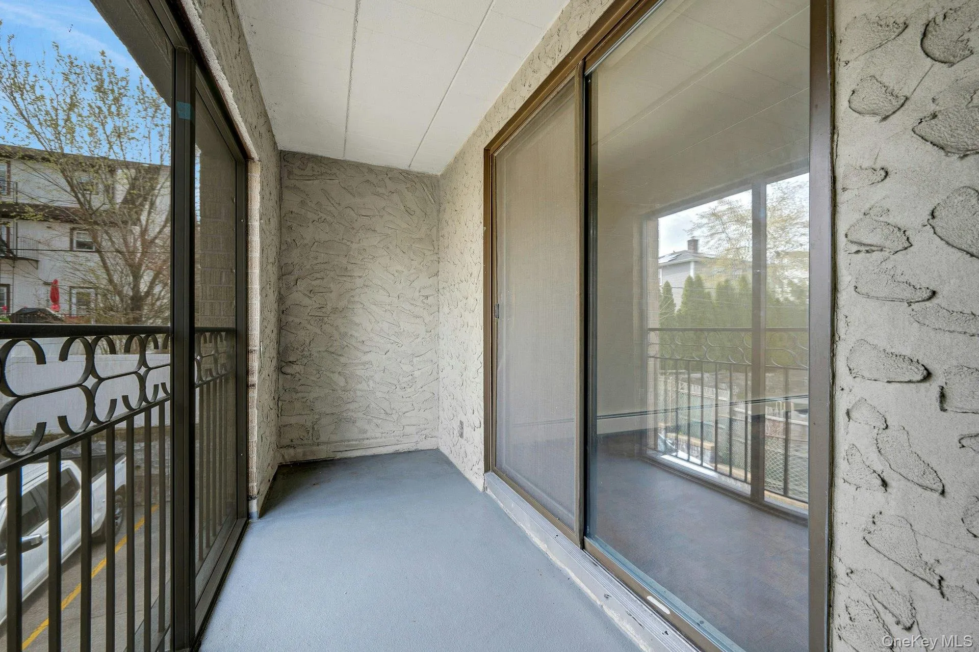 The property features a private balcony with a textured wall finish and a sliding glass door, providing an outdoor living space The property features a private balcony with a textured wall finish and a sliding glass door, providing an outdoor living space