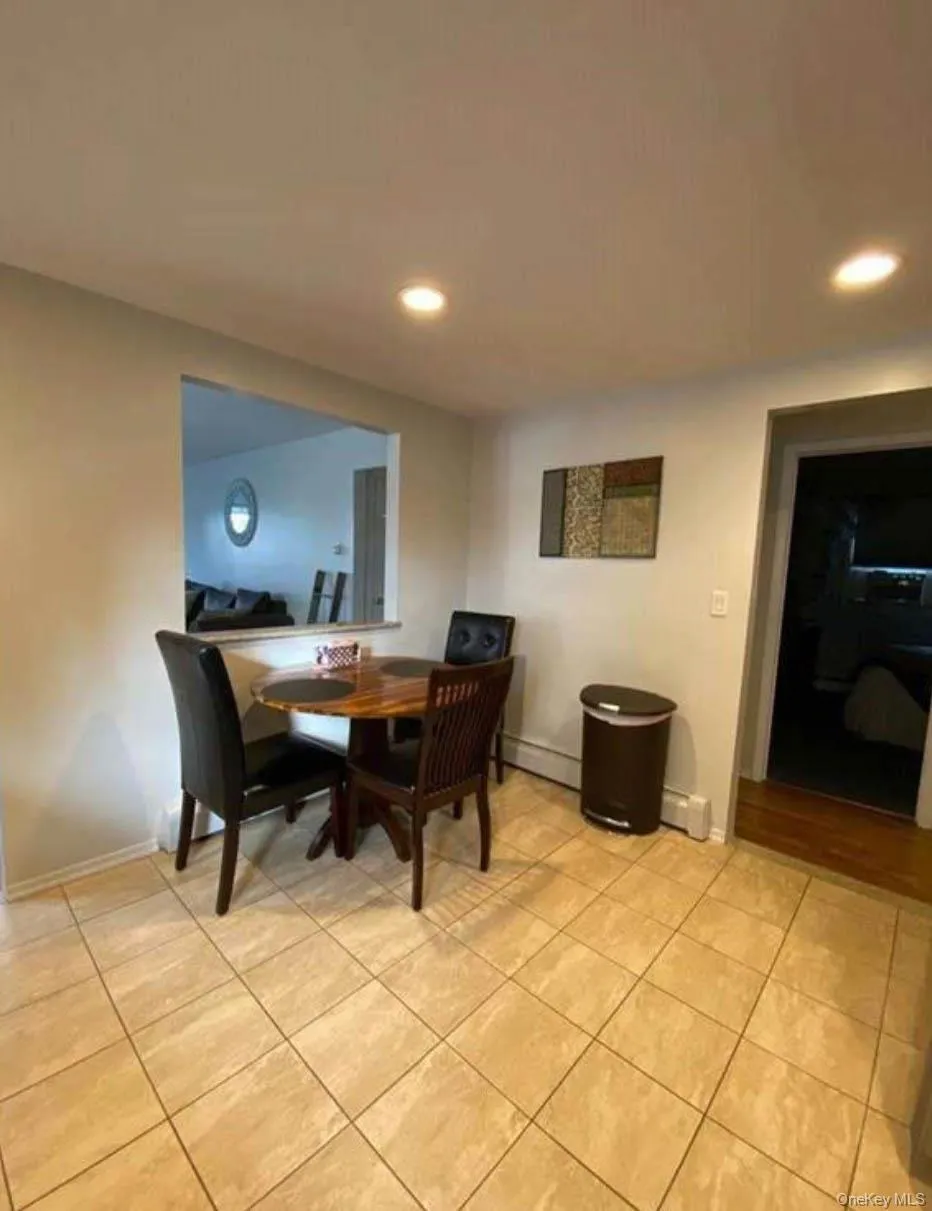 Dining area with light tile patterned floors, recessed lighting, and baseboards Dining area with light tile patterned floors, recessed lighting, and baseboards