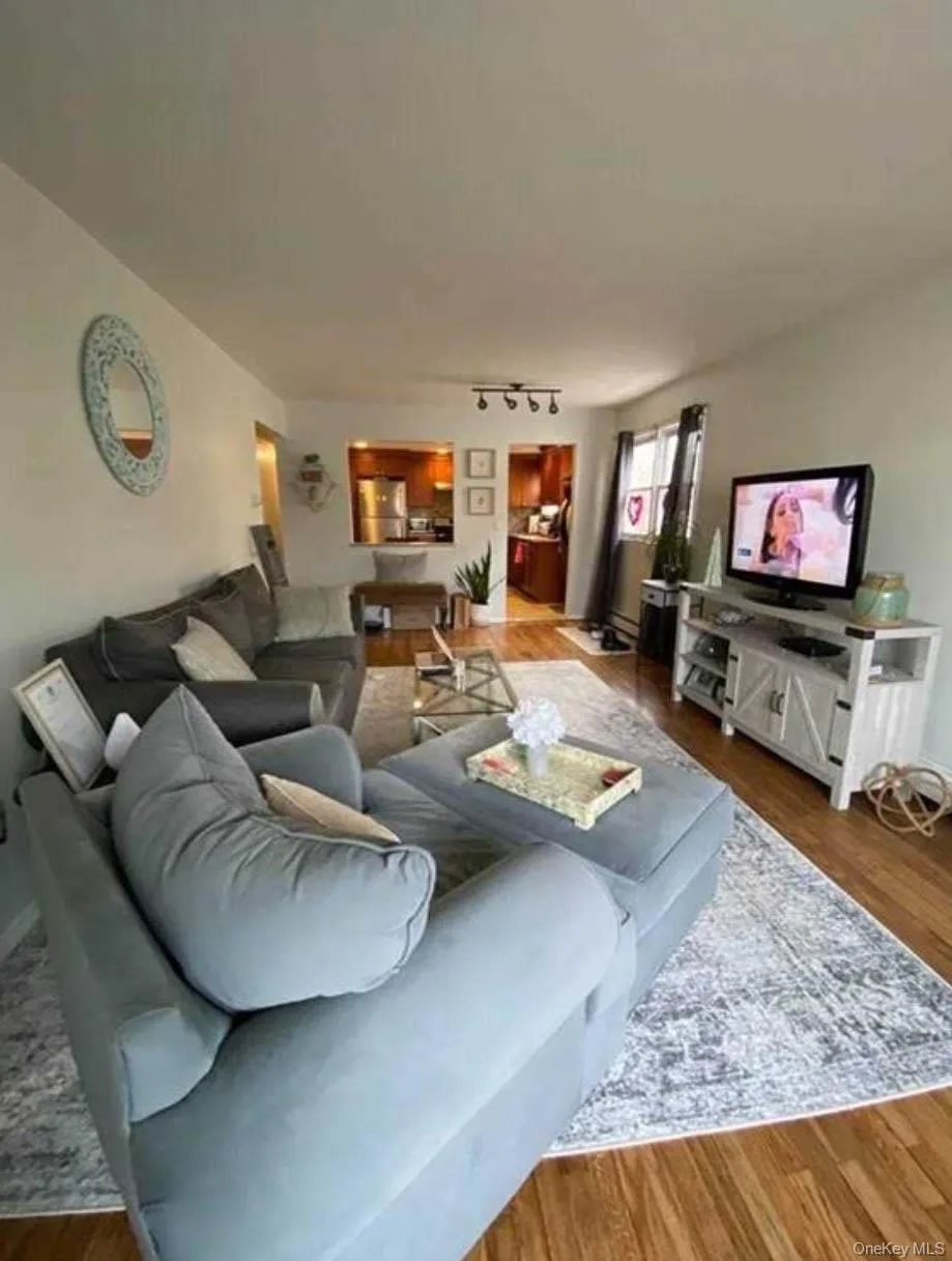 Living room with wood finished floors and track lighting Living room with wood finished floors and track lighting
