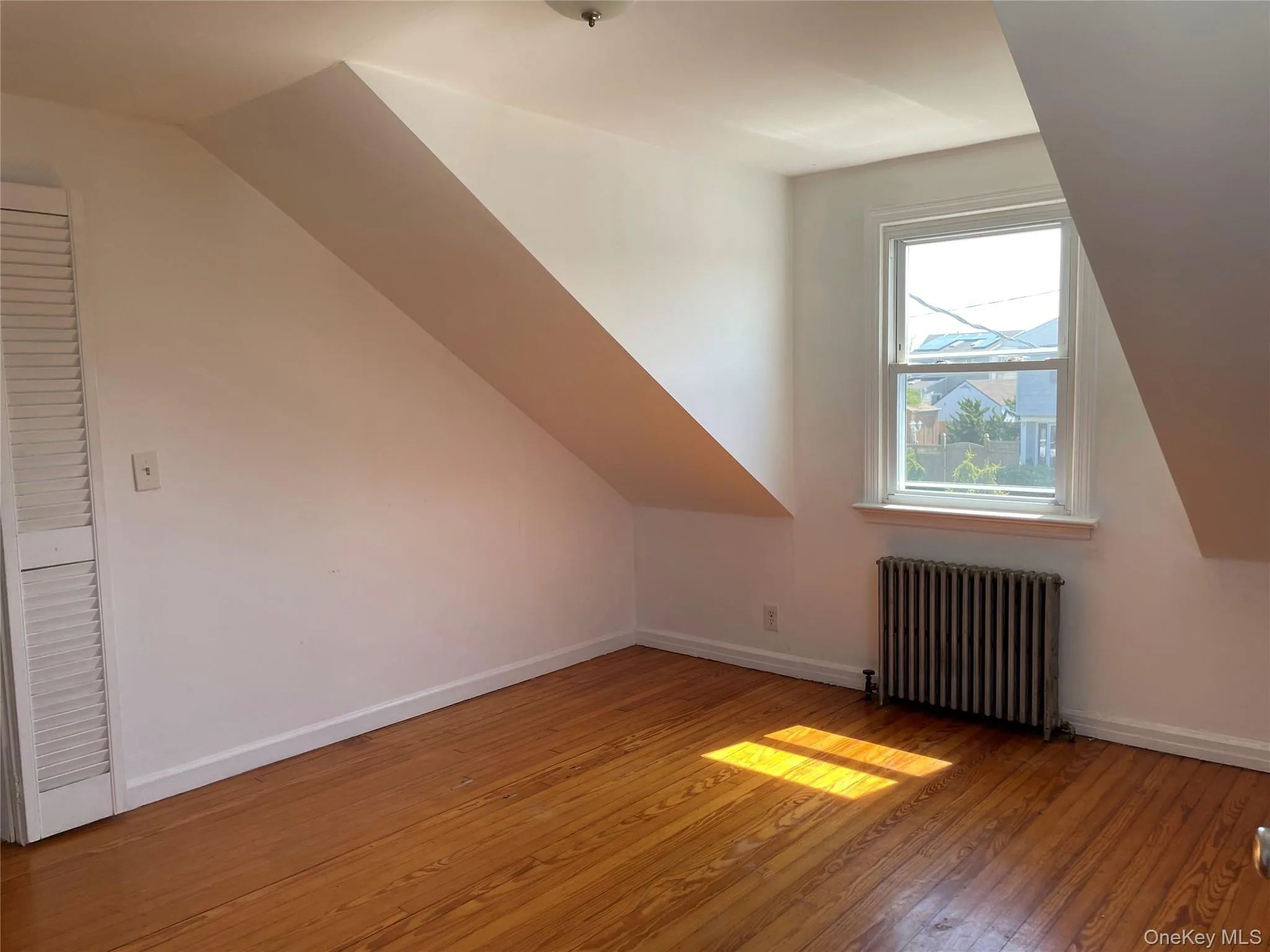 primary bedroom with wood floors primary bedroom with wood floors