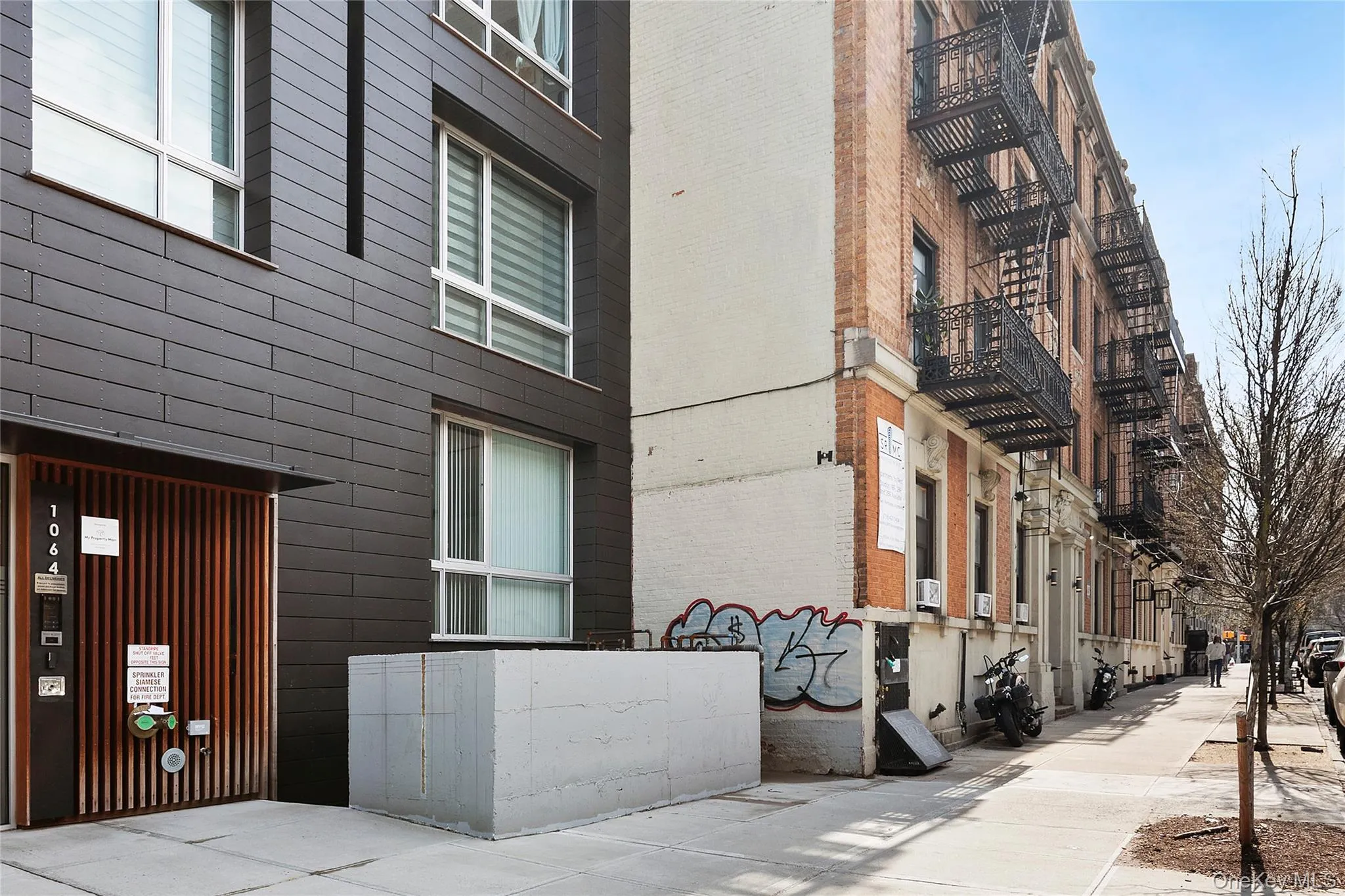 Modern facade featuring dark horizontal siding and a vertical slatted entry Modern facade featuring dark horizontal siding and a vertical slatted entry