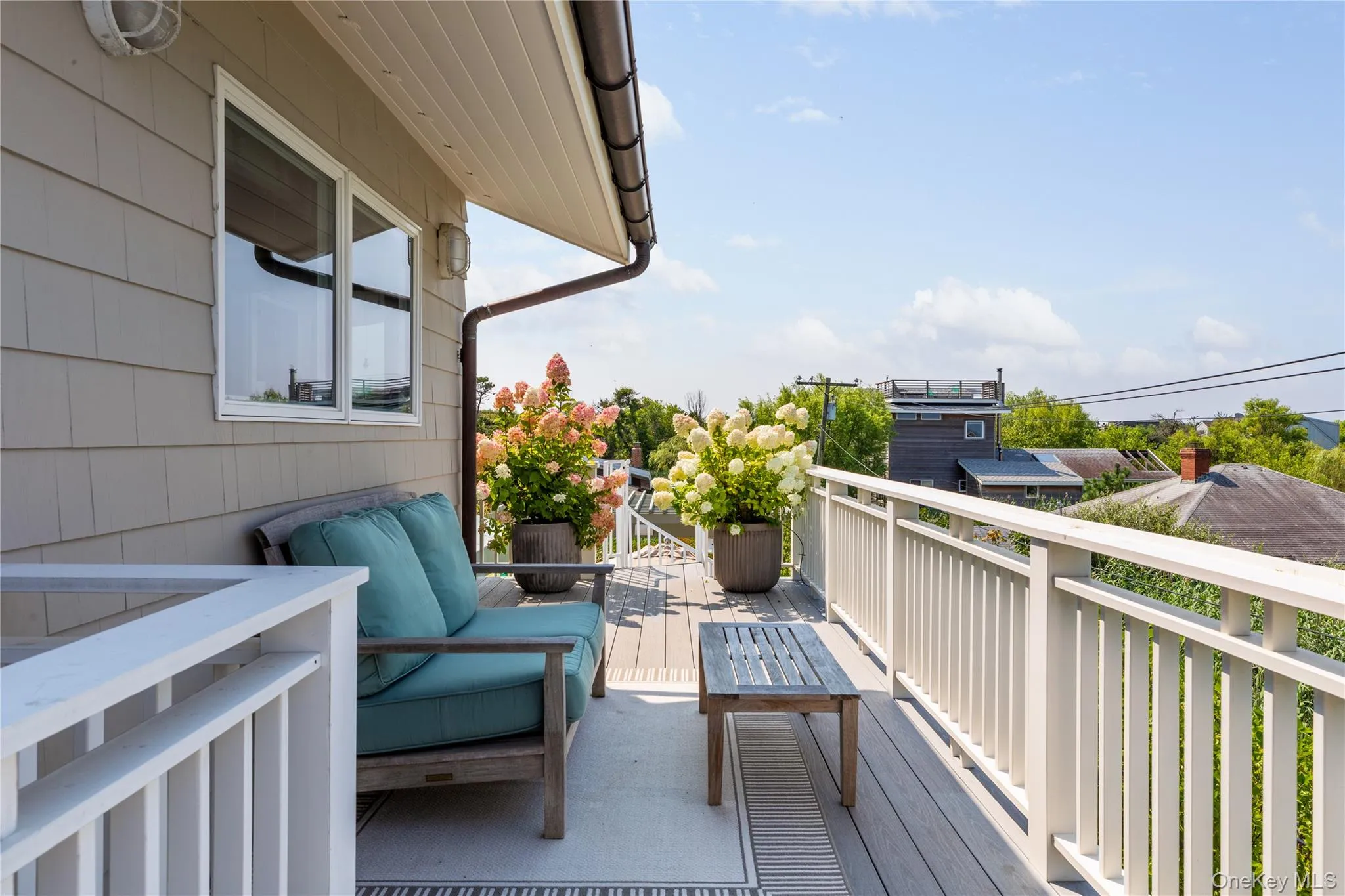 Second Floor deck with access to upstairs hall bathroom as well as second bedroom, one way glass skylight through to screened in porch below Second Floor deck with access to upstairs hall bathroom as well as second bedroom, one way glass skylight through to screened in porch below