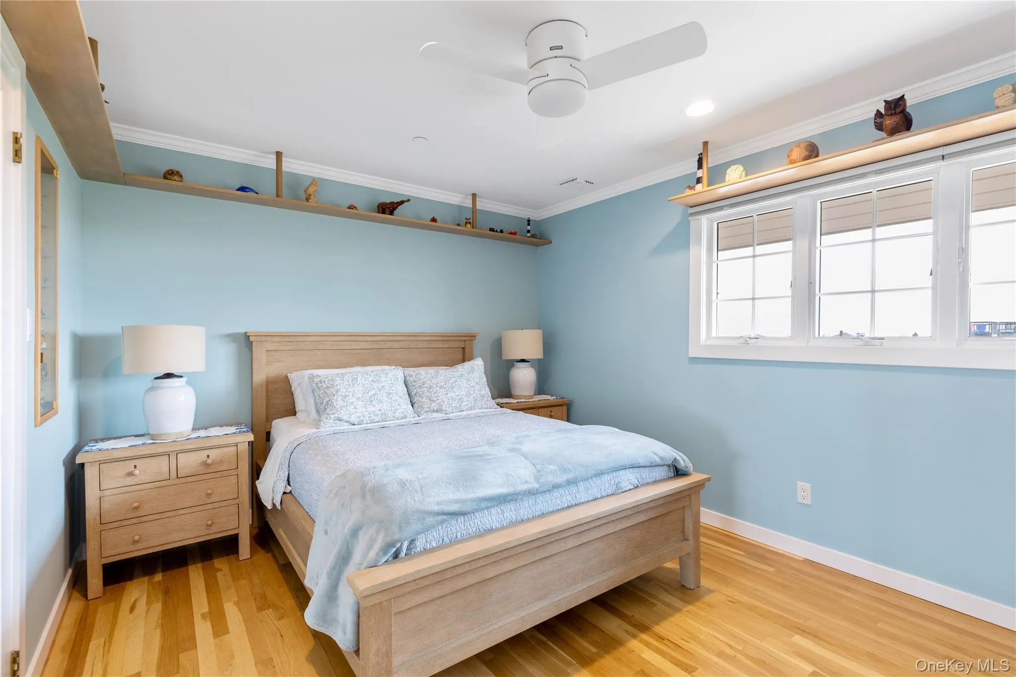Bedroom 3 with raised shelving, a custom collectors cabinet, and plenty of natural light, ceiling fan with light Bedroom 3 with raised shelving, a custom collectors cabinet, and plenty of natural light, ceiling fan with light