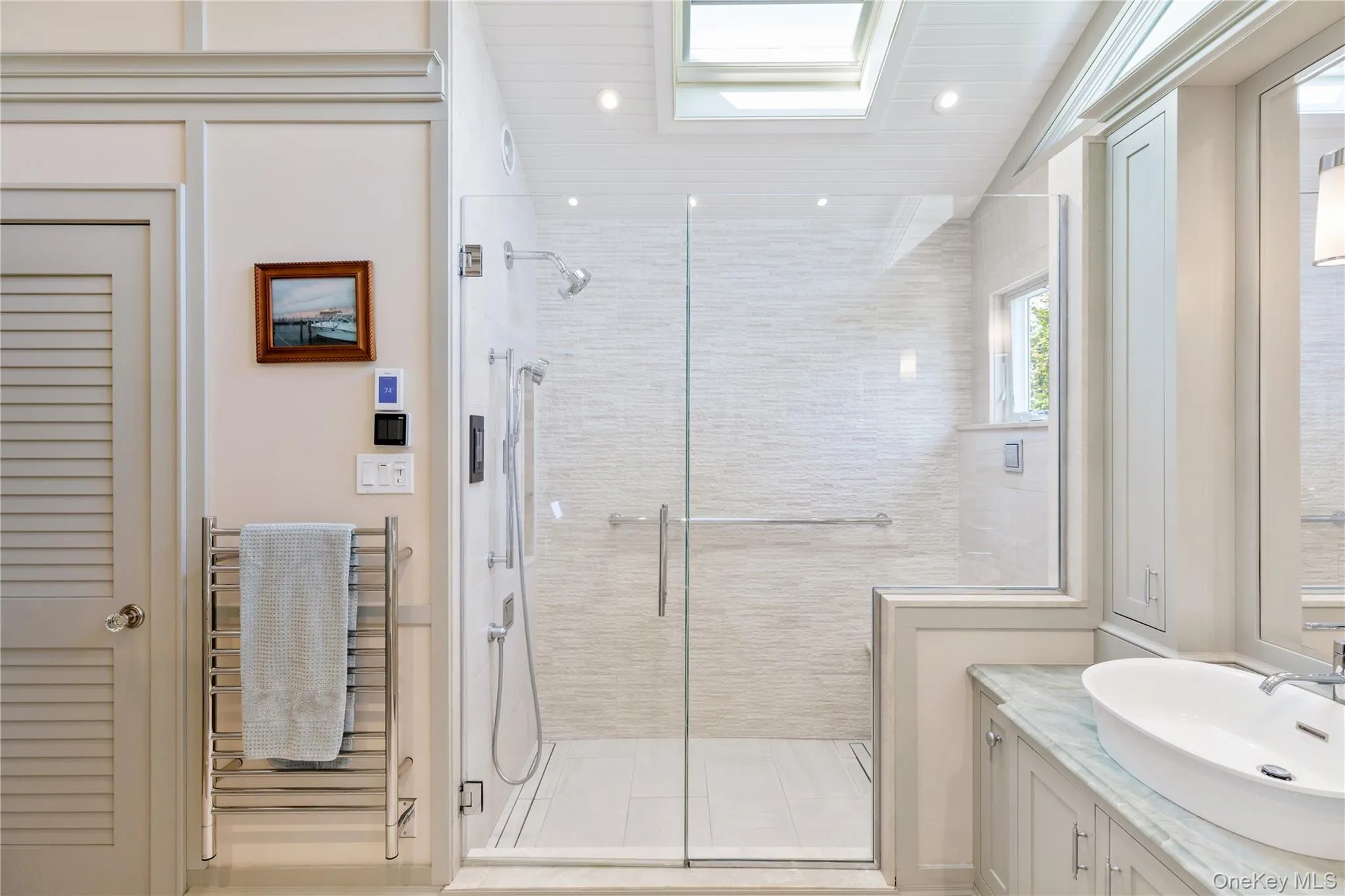 Bathroom featuring a smart shower, skylights, and towel warmer, separate toilet room Bathroom featuring a smart shower, skylights, and towel warmer, separate toilet room