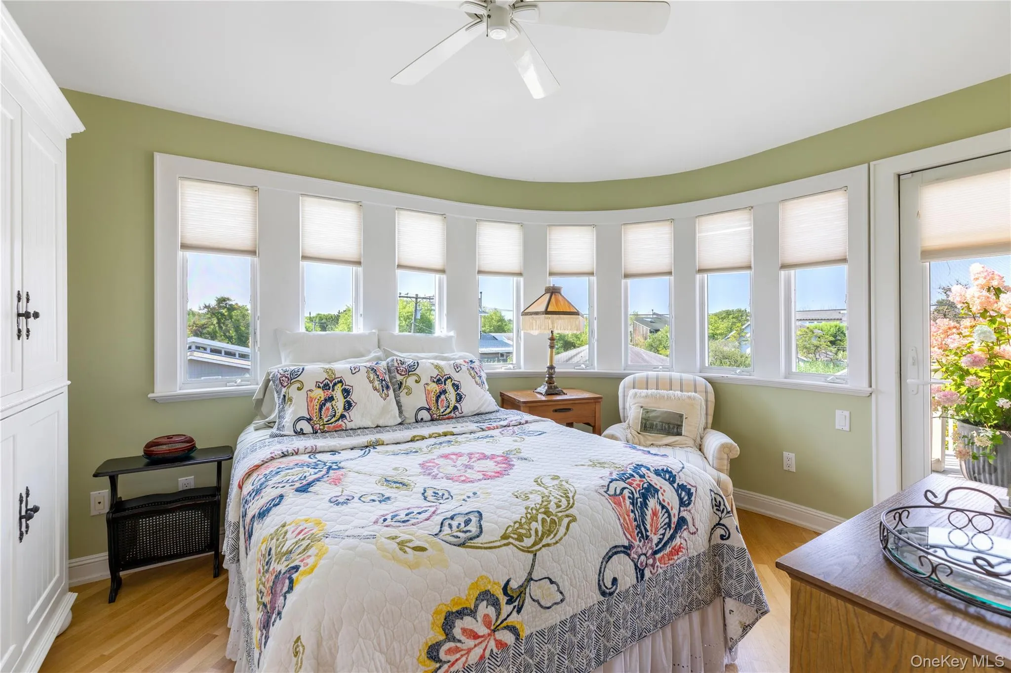 Bedroom 2, ensuite with access to exterior second floor deck, multiple windows, and hardwood floors Bedroom 2, ensuite with access to exterior second floor deck, multiple windows, and hardwood floors