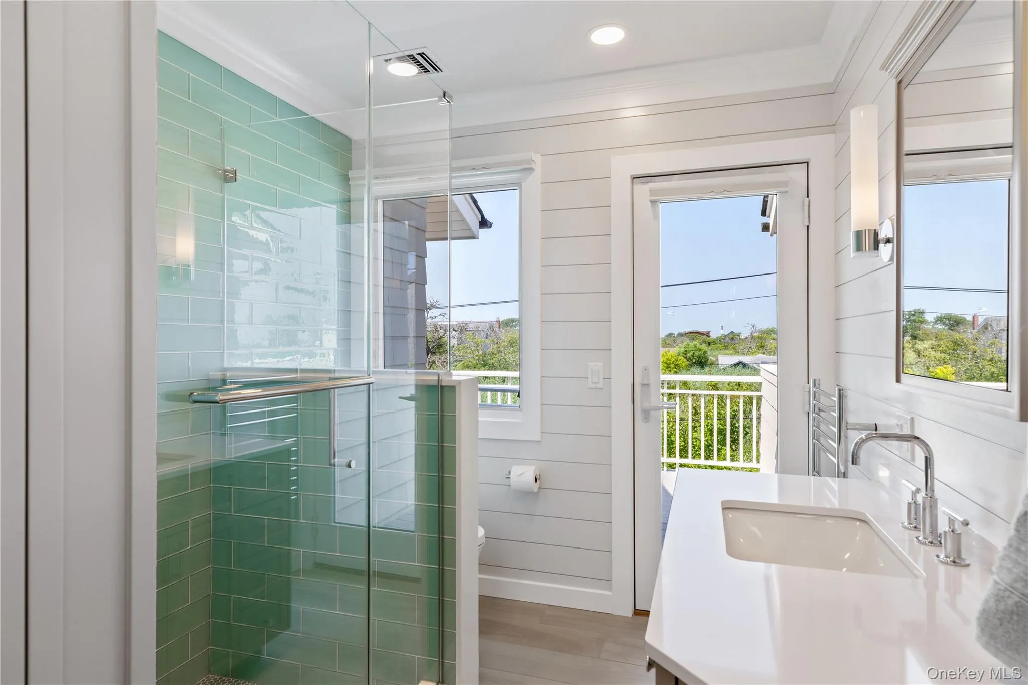 Brand new Bathroom as of 2024 featuring towel warmer, radiant heated floors, and custom built linen cabinetry, gorgeous single vanity, and a custom cut glass shower with hand sprayer Brand new Bathroom as of 2024 featuring towel warmer, radiant heated floors, and custom built linen cabinetry, gorgeous single vanity, and a custom cut glass shower with hand sprayer