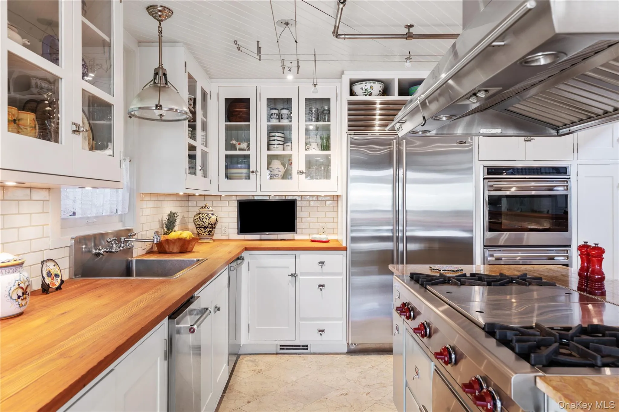 Deep Stainless Sink with swivel spout, television mounted to backsplash, Sub Zero Stainless Refrigerator / Freezer Deep Stainless Sink with swivel spout, television mounted to backsplash, Sub Zero Stainless Refrigerator / Freezer