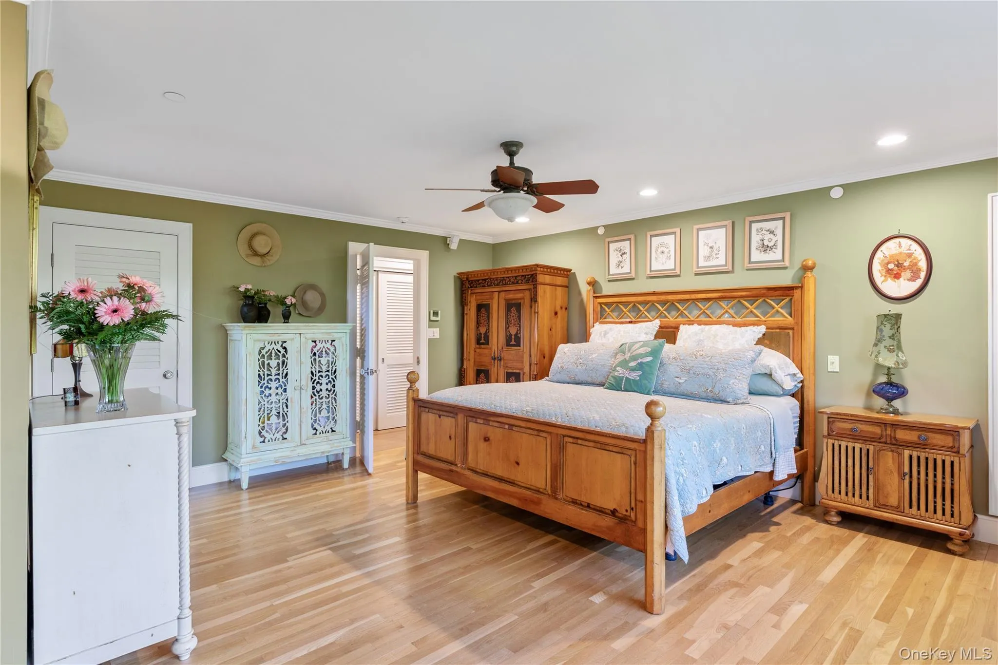 Primary Bedroom featuring ornamental crown moulding, ceiling fan, light wood finished floors, and recessed lighting Primary Bedroom featuring ornamental crown moulding, ceiling fan, light wood finished floors, and recessed lighting