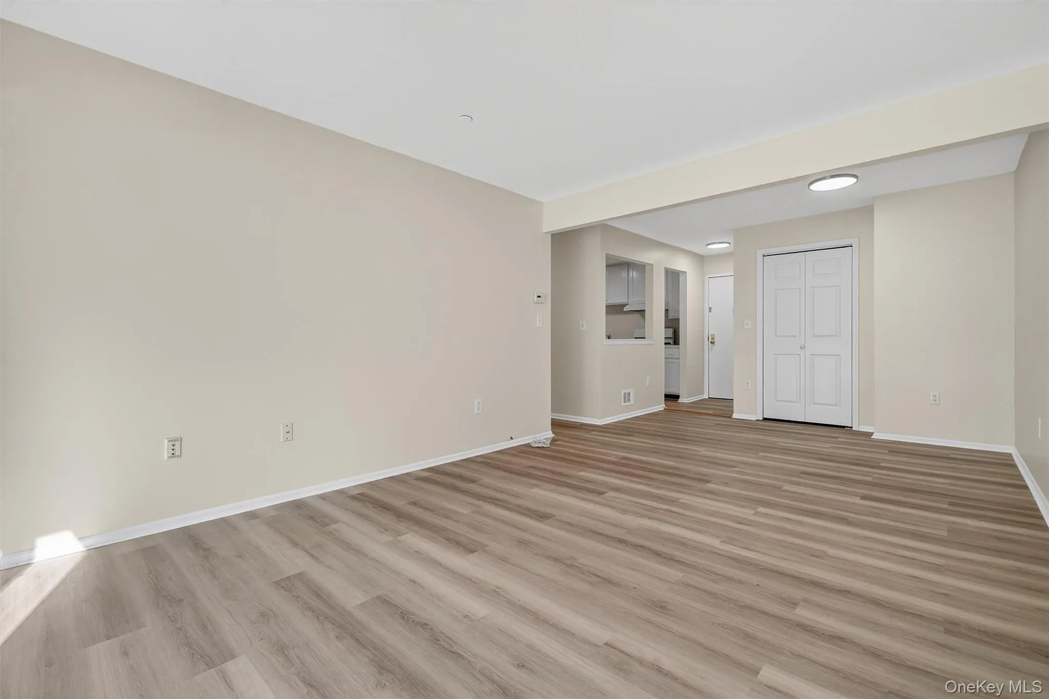 Unfurnished room with light wood finished floors and baseboards Unfurnished room with light wood finished floors and baseboards