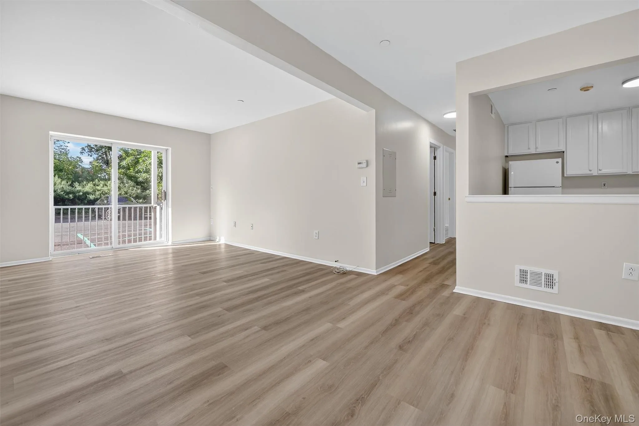 Unfurnished living room featuring light wood finished floors Unfurnished living room featuring light wood finished floors
