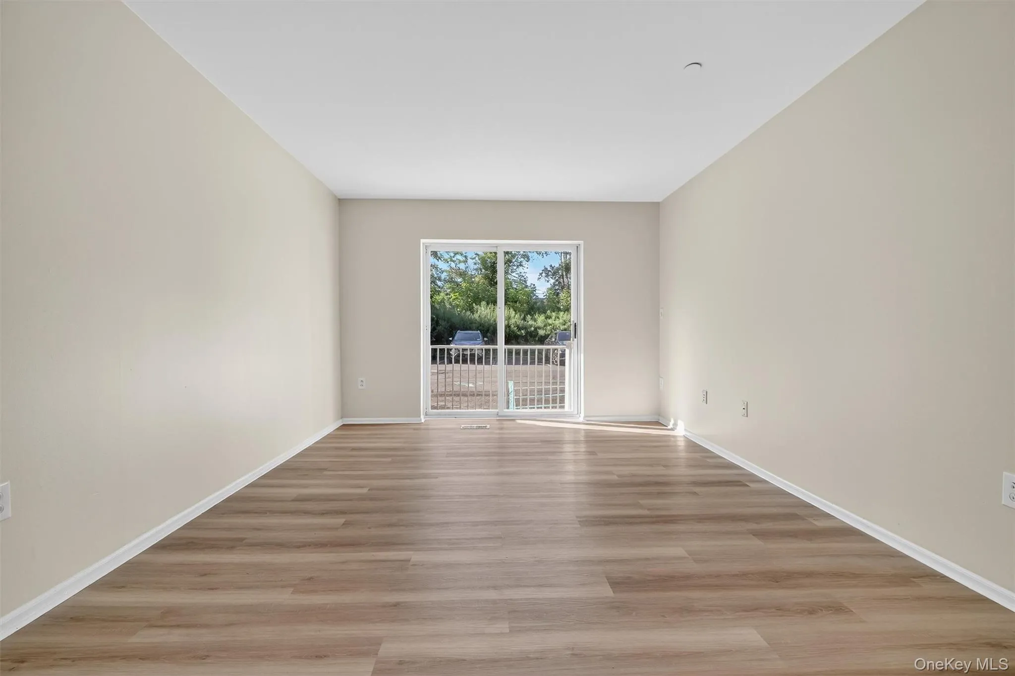 Empty room featuring light wood-style flooring and baseboards Empty room featuring light wood-style flooring and baseboards