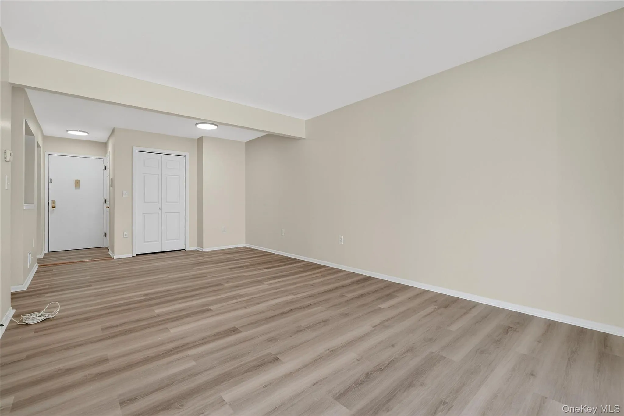 Spare room featuring light wood finished floors and baseboards Spare room featuring light wood finished floors and baseboards