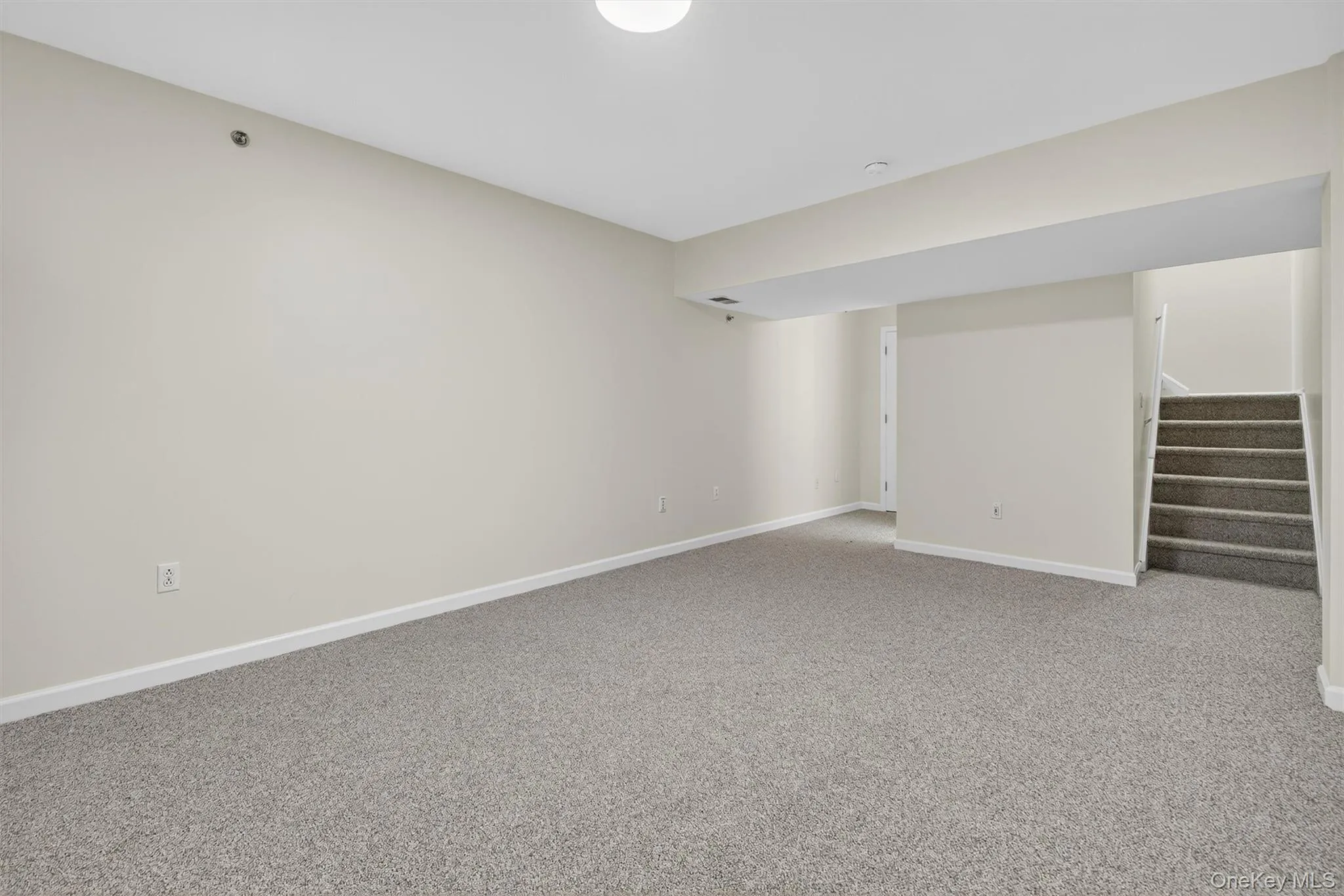 Finished basement with stairs and carpet floors Finished basement with stairs and carpet floors