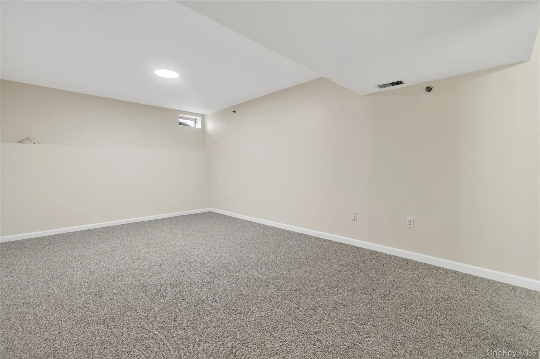 Unfurnished room with carpet flooring and baseboards Unfurnished room with carpet flooring and baseboards