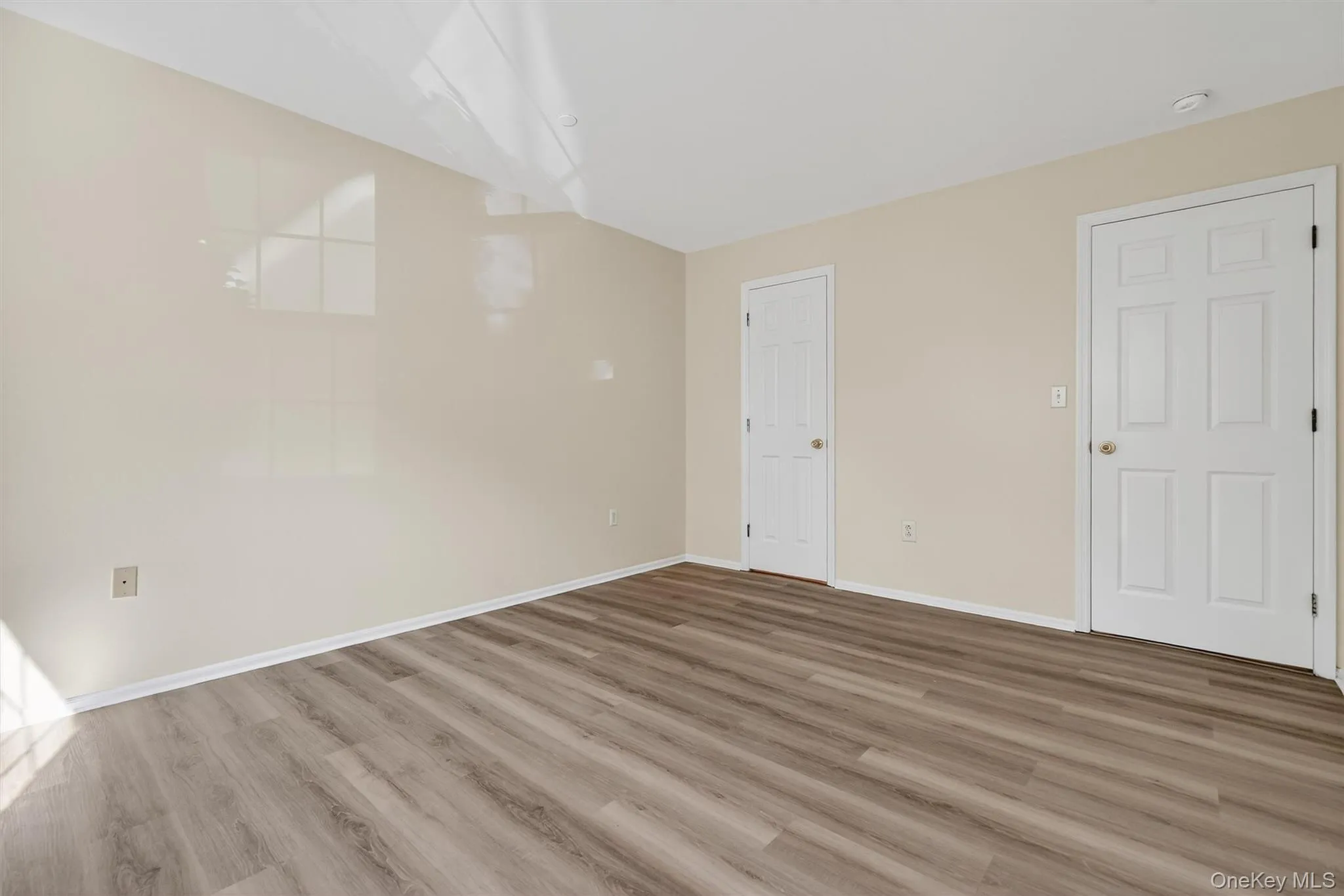 Unfurnished bedroom with wood finished floors and baseboards Unfurnished bedroom with wood finished floors and baseboards