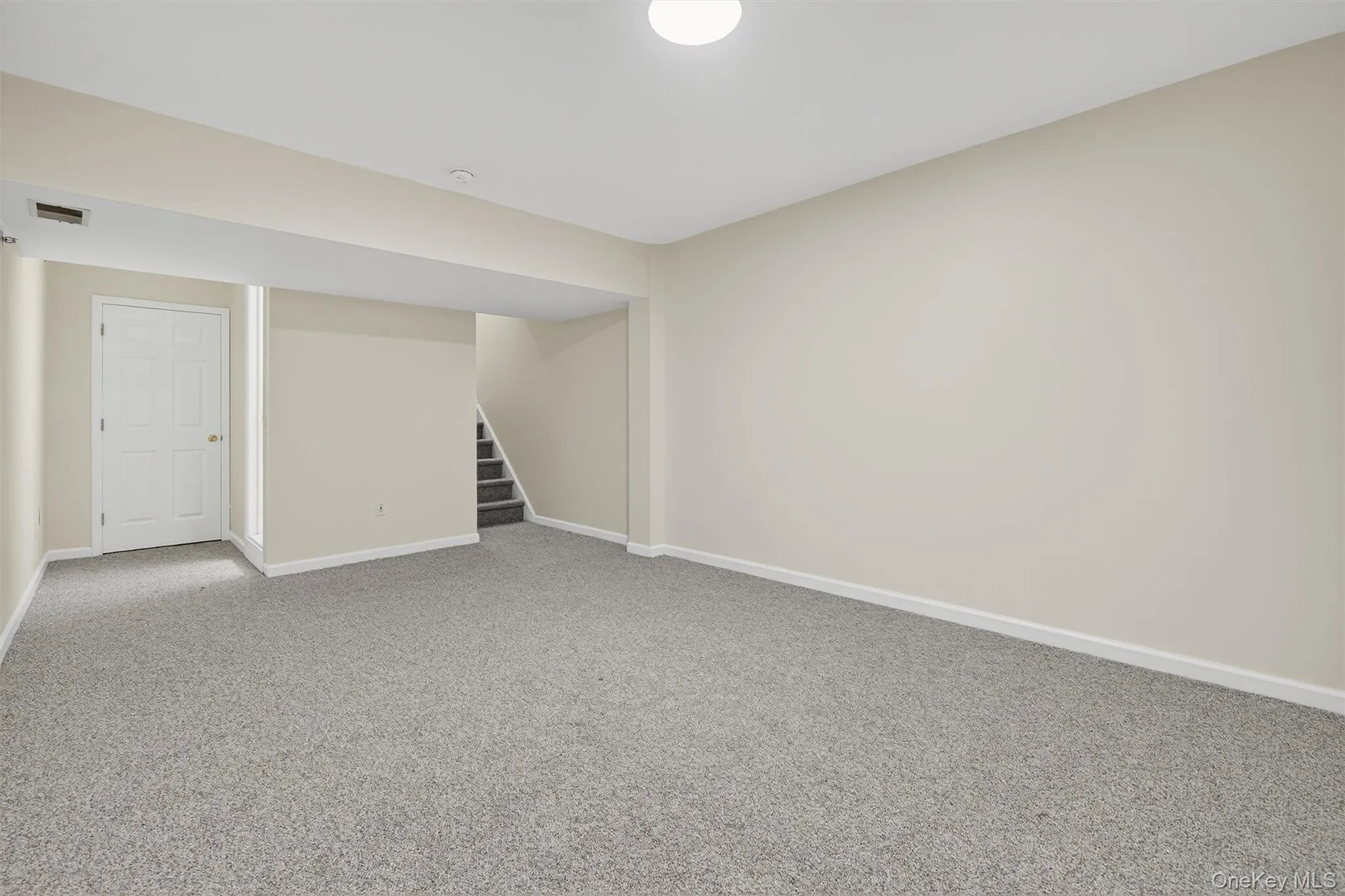 Finished basement with carpet floors and stairs Finished basement with carpet floors and stairs