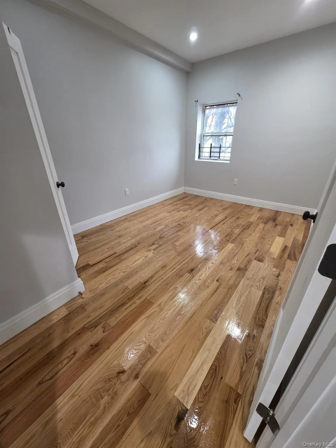 Hardwood flooring complemented by light gray walls and white trim Hardwood flooring complemented by light gray walls and white trim
