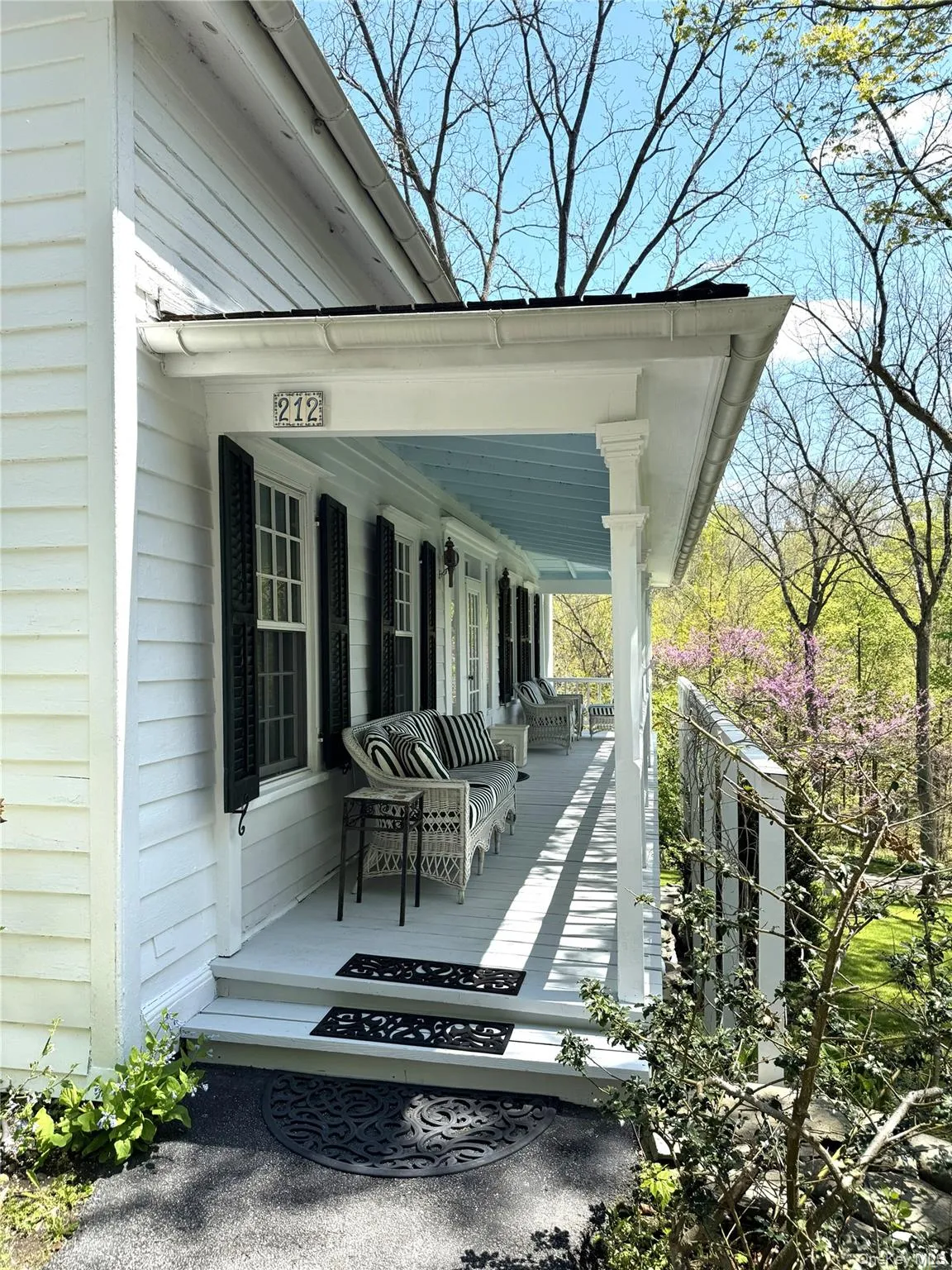 A gracious welcome. Relax on the covered front porch, framed by a wisteria-draped arbor and overlooking the manicured grounds. A gracious welcome. Relax on the covered front porch, framed by a wisteria-draped arbor and overlooking the manicured grounds.