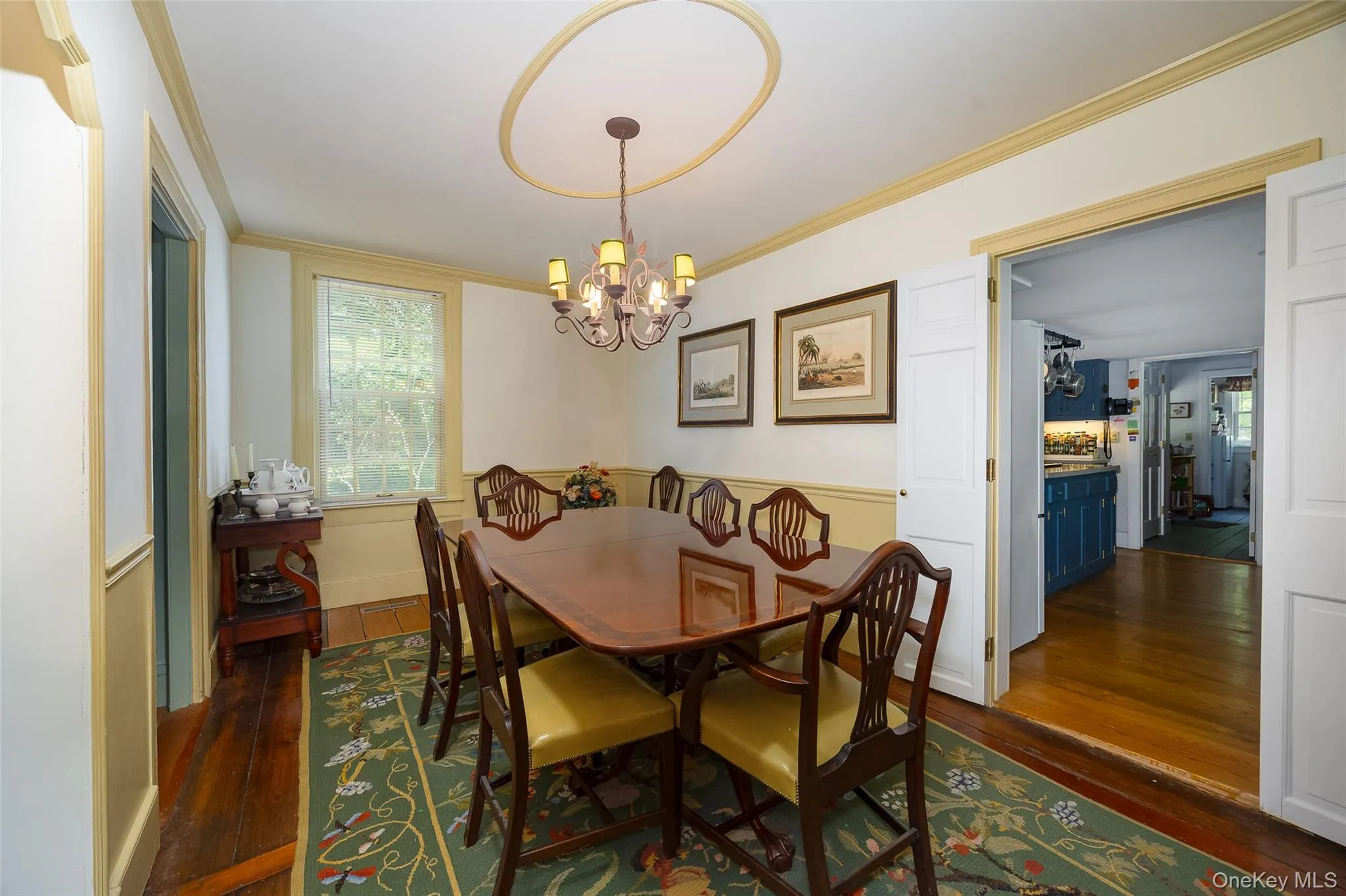 Dining room featuring hardwood flooring, a decorative ceiling medallion, and a multi-light chandelier Dining room featuring hardwood flooring, a decorative ceiling medallion, and a multi-light chandelier
