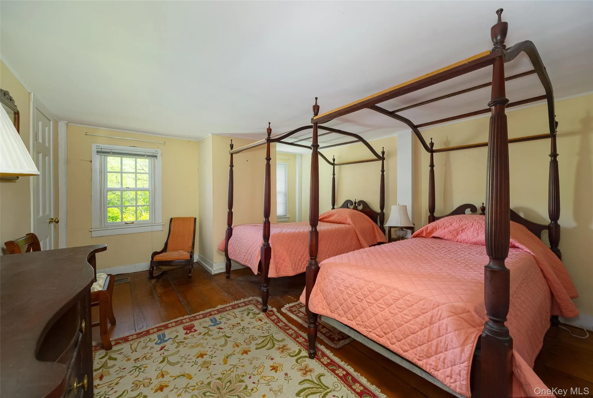 Hardwood flooring throughout this room, featuring a double-pane window and a classic paneled door Hardwood flooring throughout this room, featuring a double-pane window and a classic paneled door