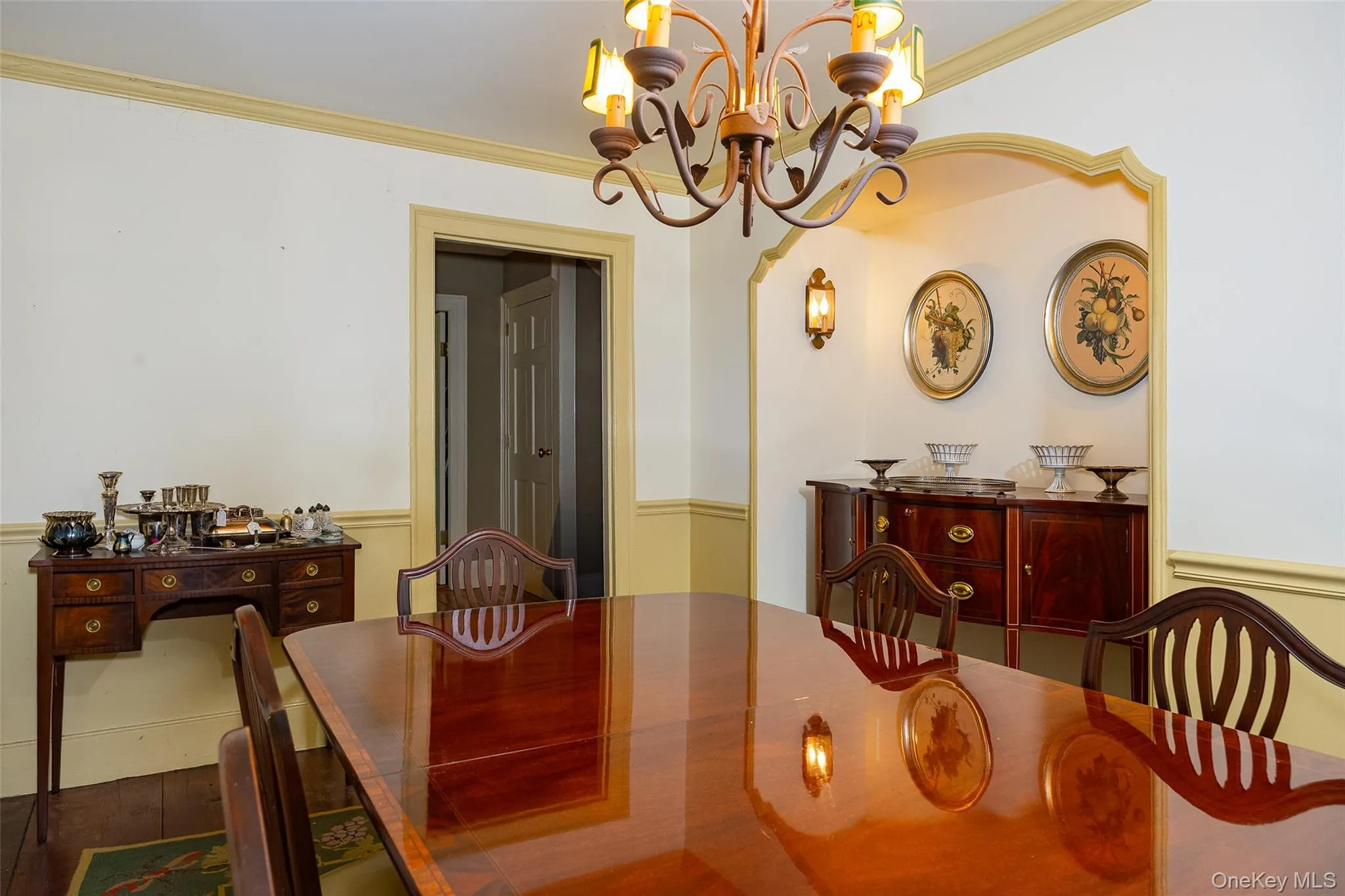 Dining area featuring a decorative chandelier, alcove, and wall sconce lighting Dining area featuring a decorative chandelier, alcove, and wall sconce lighting