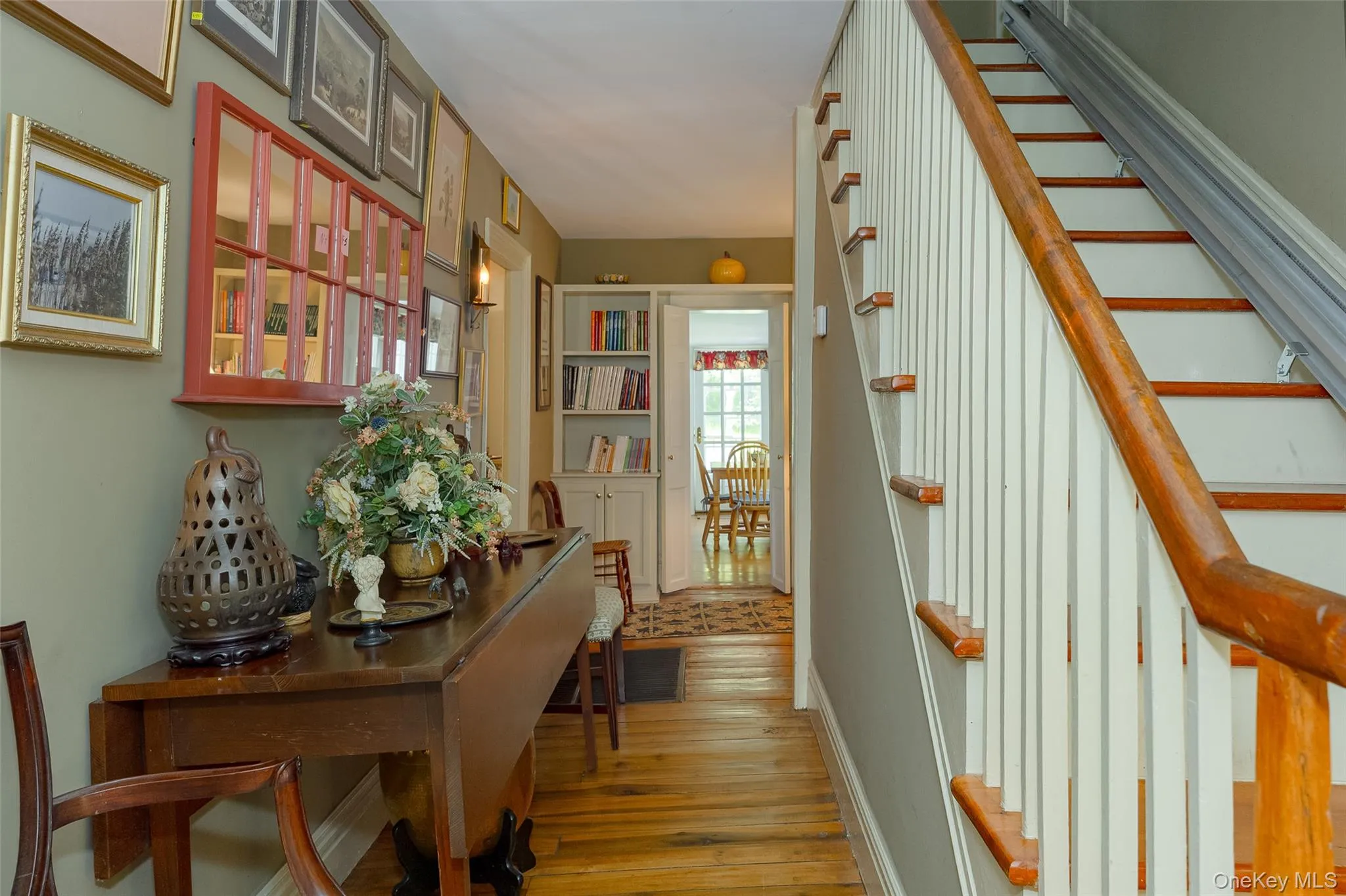 Hardwood flooring throughout the entry hallway and built-in cabinets Hardwood flooring throughout the entry hallway and built-in cabinets