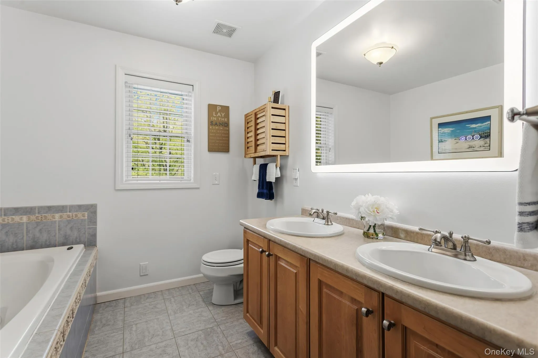 with whirlpool tub, shower stall, double sinks and linen closet with whirlpool tub, shower stall, double sinks and linen closet