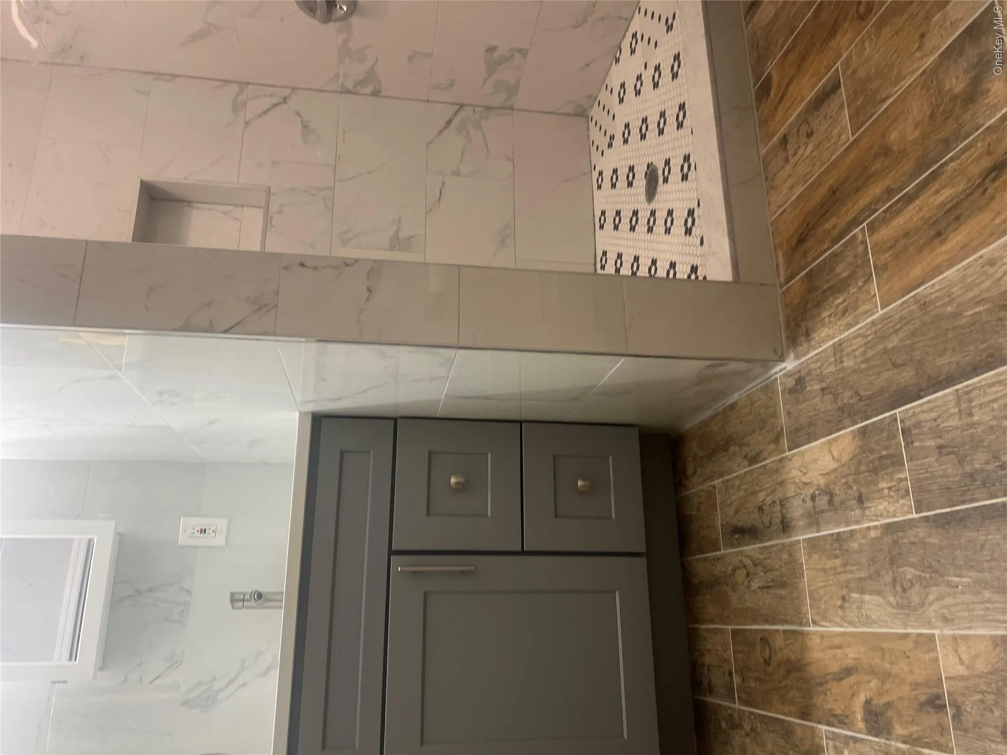 This bathroom features a vanity with a gray cabinet, a white countertop, and a chrome faucet This bathroom features a vanity with a gray cabinet, a white countertop, and a chrome faucet