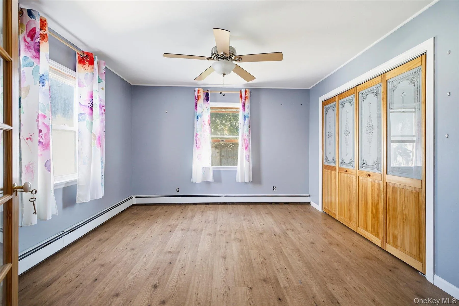 First Floor Primary wood-finish flooring, ceiling fan, and French doors. First Floor Primary wood-finish flooring, ceiling fan, and French doors.