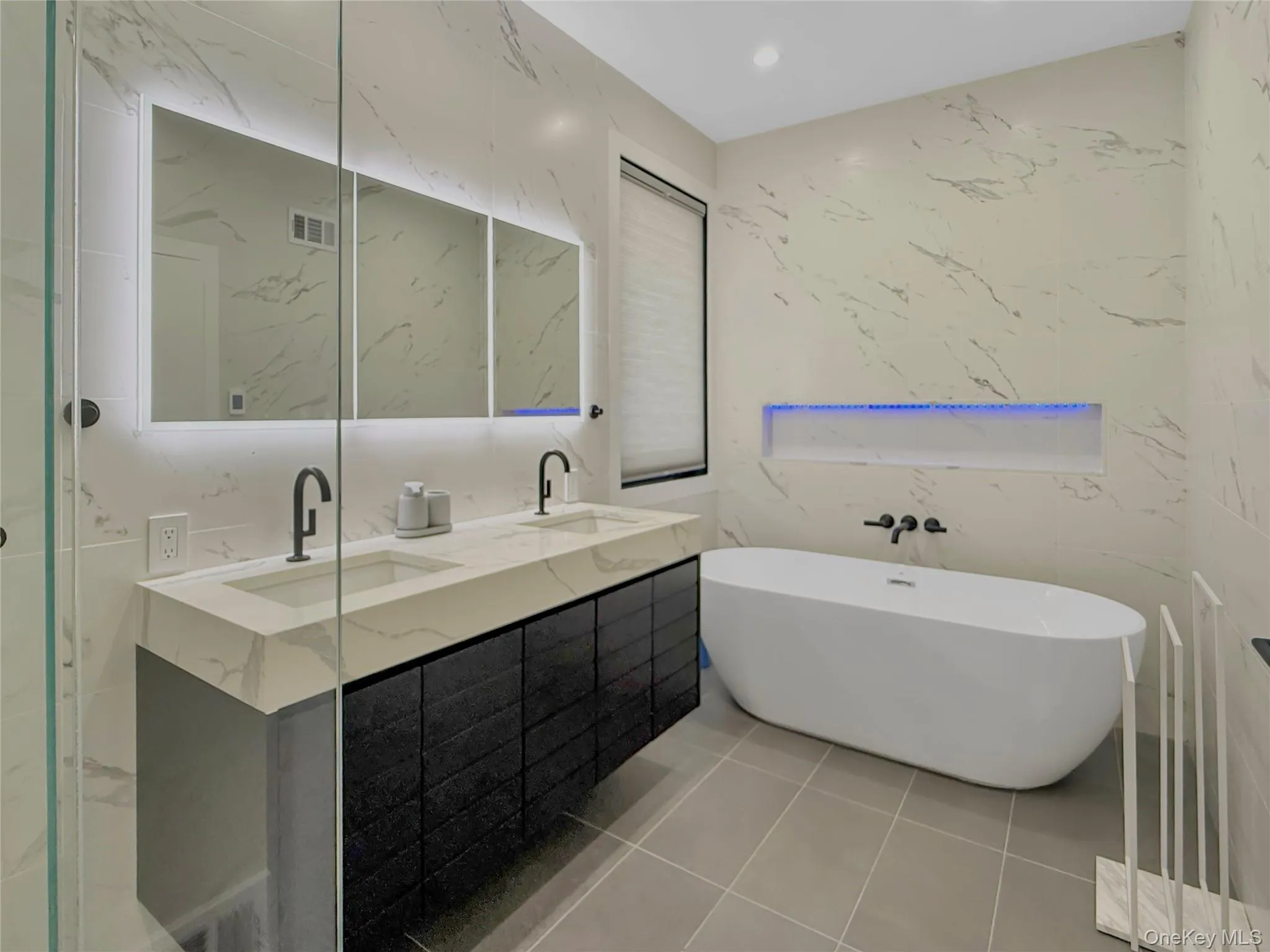 Full bathroom on first floor with double vanity, shower and soaking tub and separate shower Full bathroom on first floor with double vanity, shower and soaking tub and separate shower