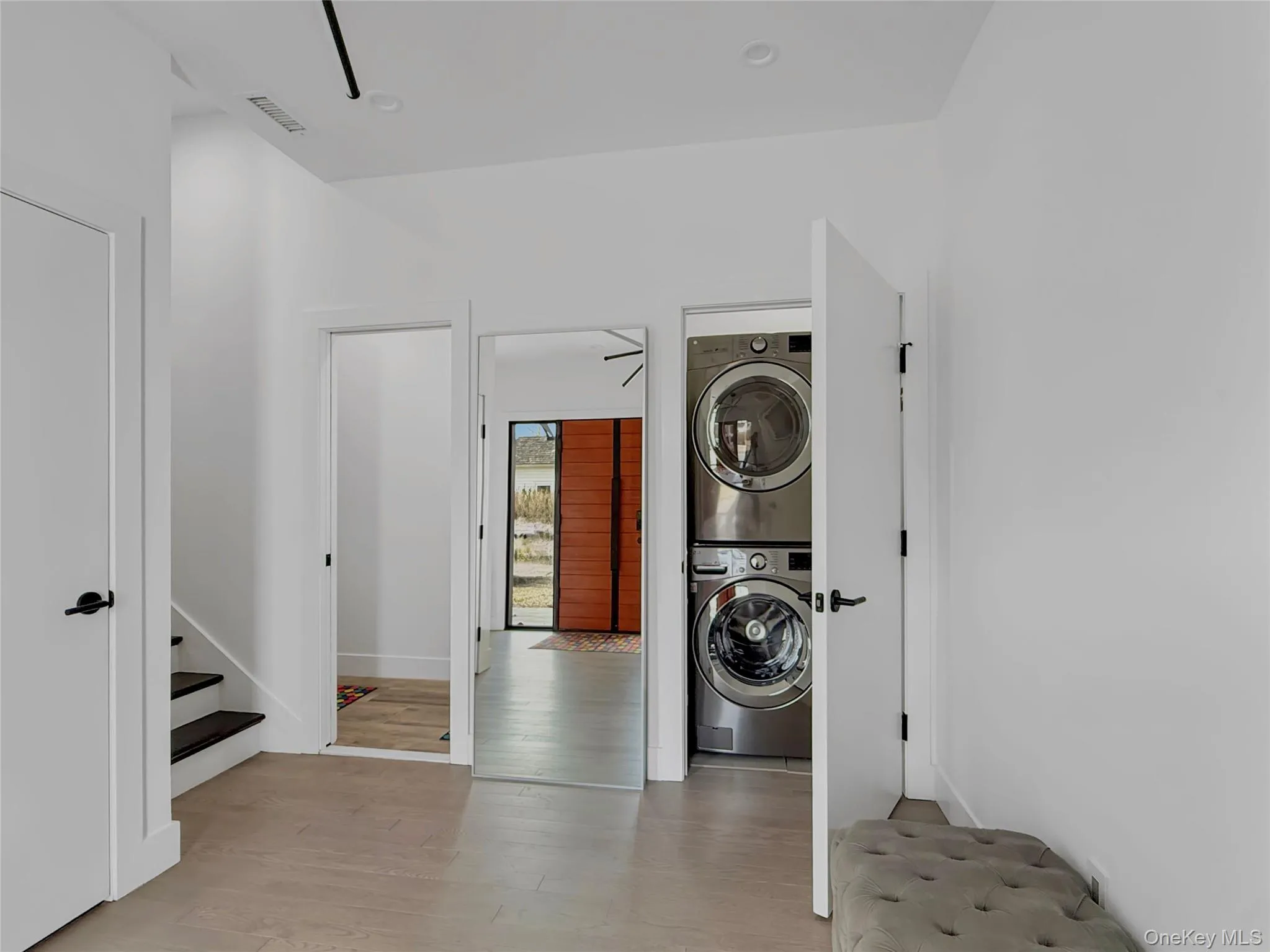 Entrance with washer/dryer, stairs to second floor, coat closet and half bath Entrance with washer/dryer, stairs to second floor, coat closet and half bath