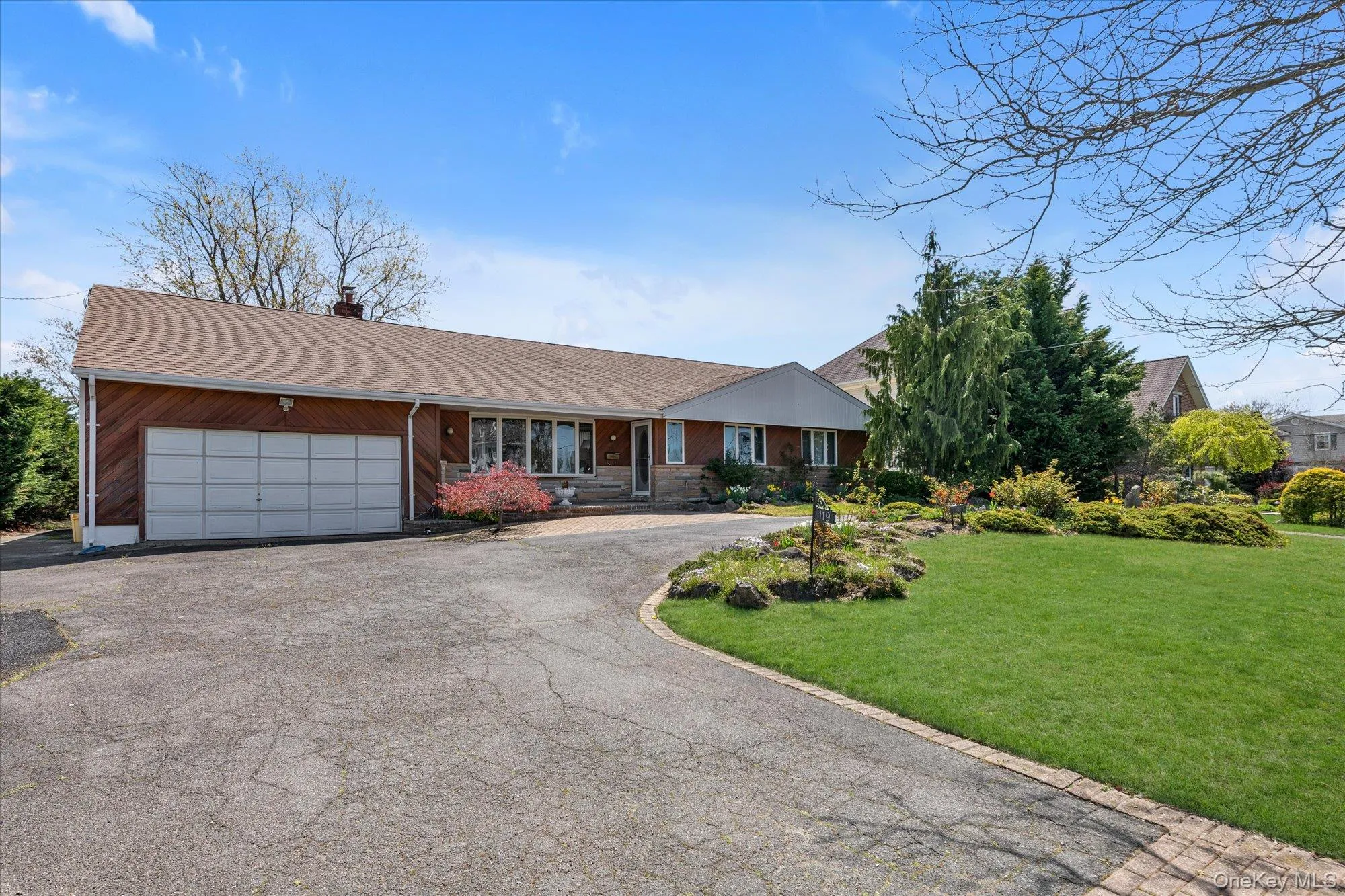 Two-car garage, and a paved driveway with brick edging Two-car garage, and a paved driveway with brick edging