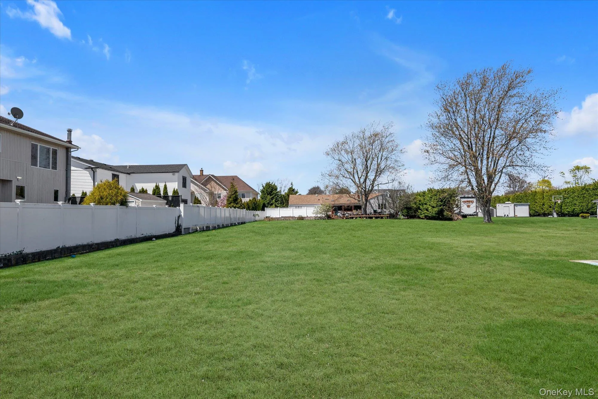 Expansive green lawn providing ample outdoor space Expansive green lawn providing ample outdoor space
