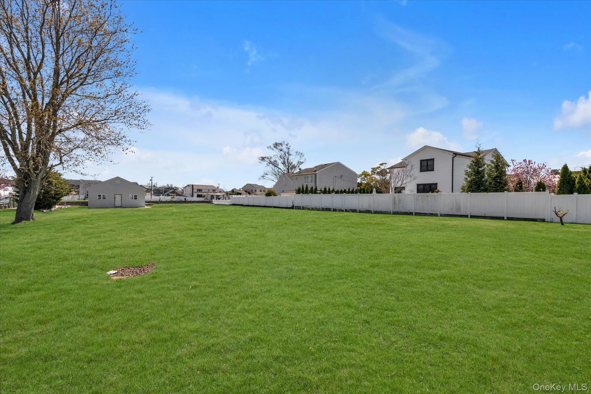 Expansive green lawn providing ample open space Expansive green lawn providing ample open space